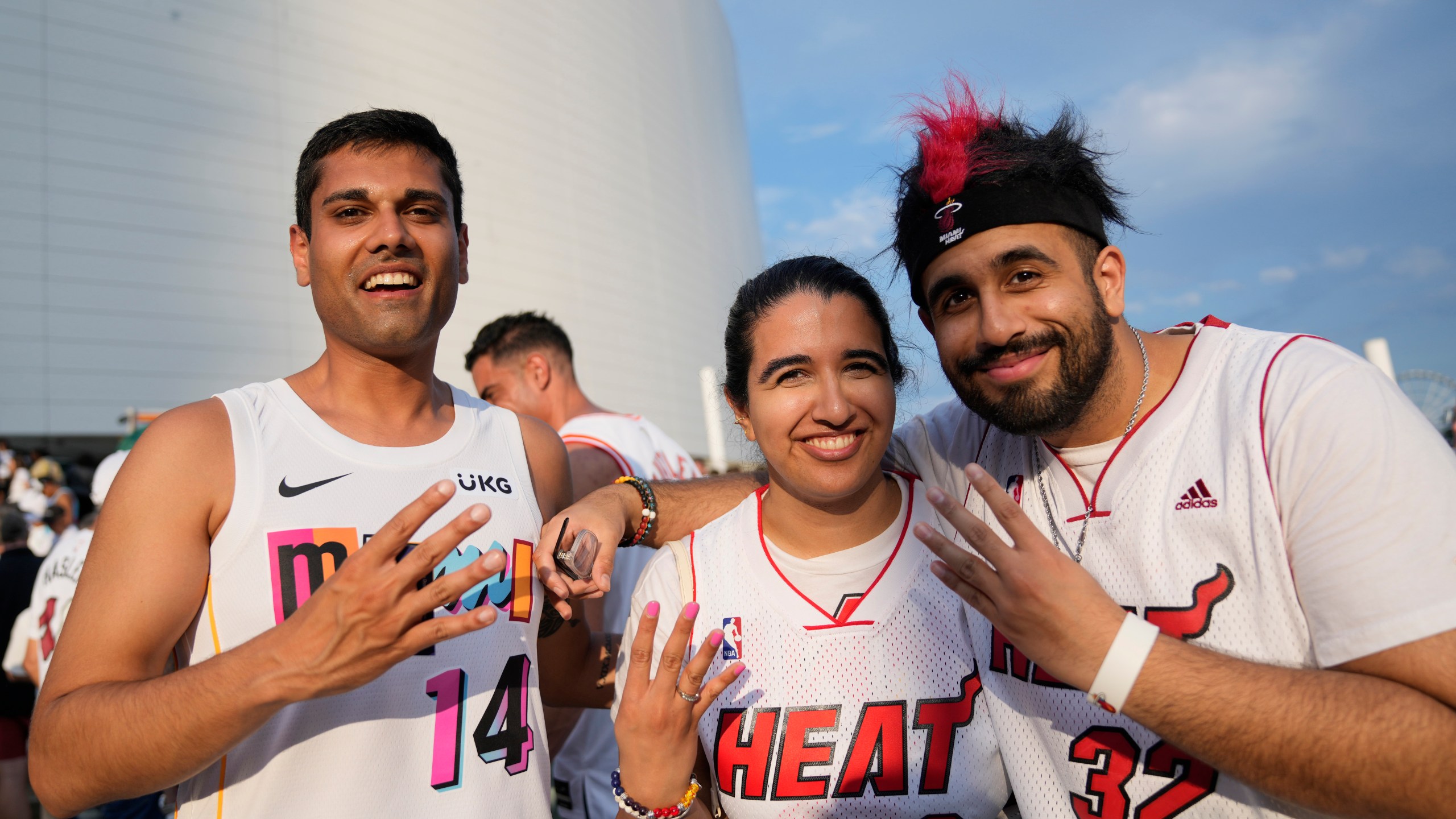 Rishabh Goel, left, and siblings Karishma, center, and Sid Chadha, Miami Heat fans from New Jersey, wait to enter the arena for Game 3 of the NBA Finals basketball game against the Denver Nuggets, Wednesday, June 7, 2023, in Miami. (AP Photo/Rebecca Blackwell)