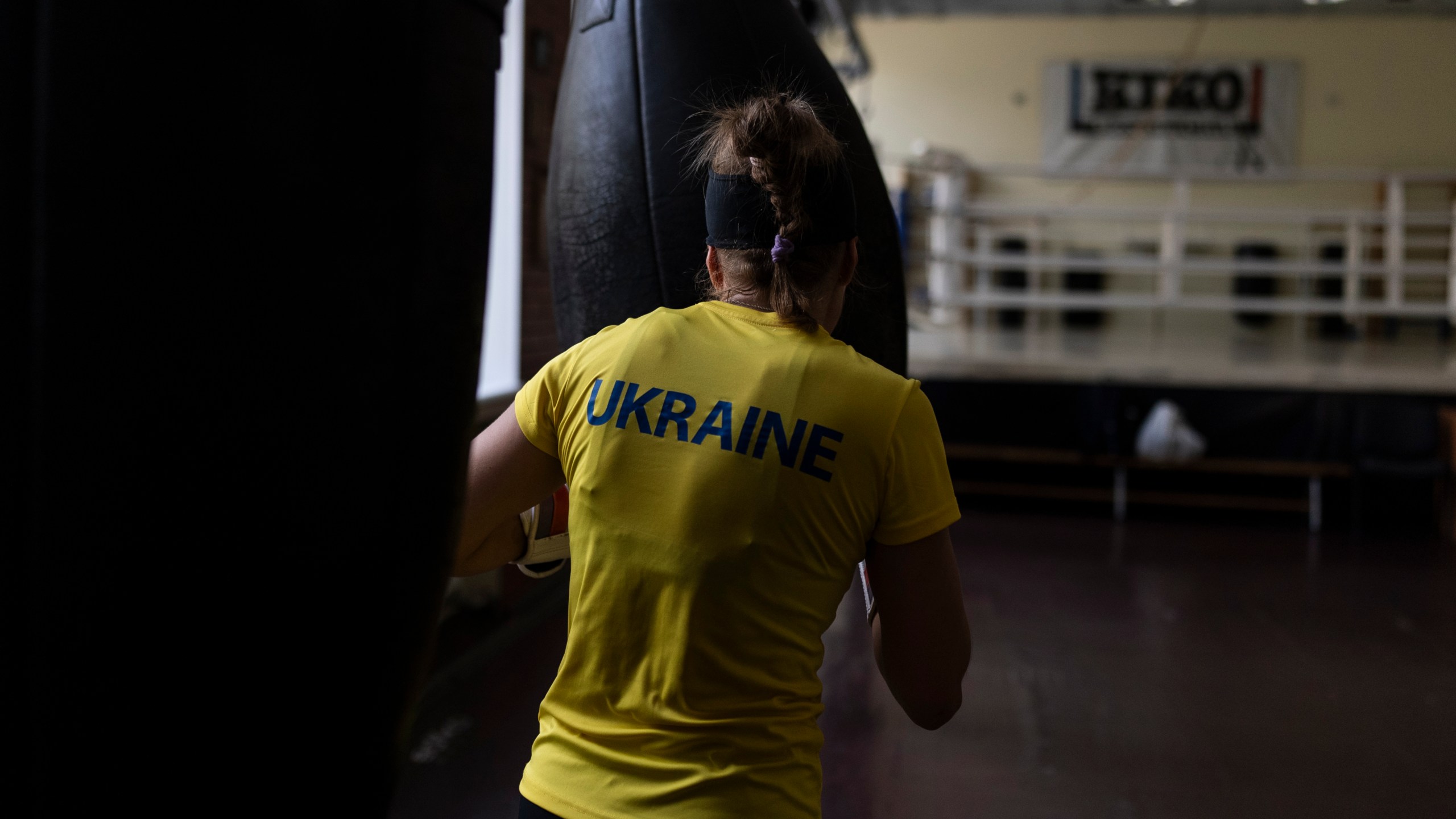 Ukrainian boxer Anna Lysenko hits a punching bag, during her training at Kiko Boxing Club in Kyiv, Ukraine, Thursday, July 6, 2023. Lysenko dedicates long hours preparing for next year's Paris Olympics despite the unsettling sounds of explosions booming outside. (AP Photo/Jae C. Hong)