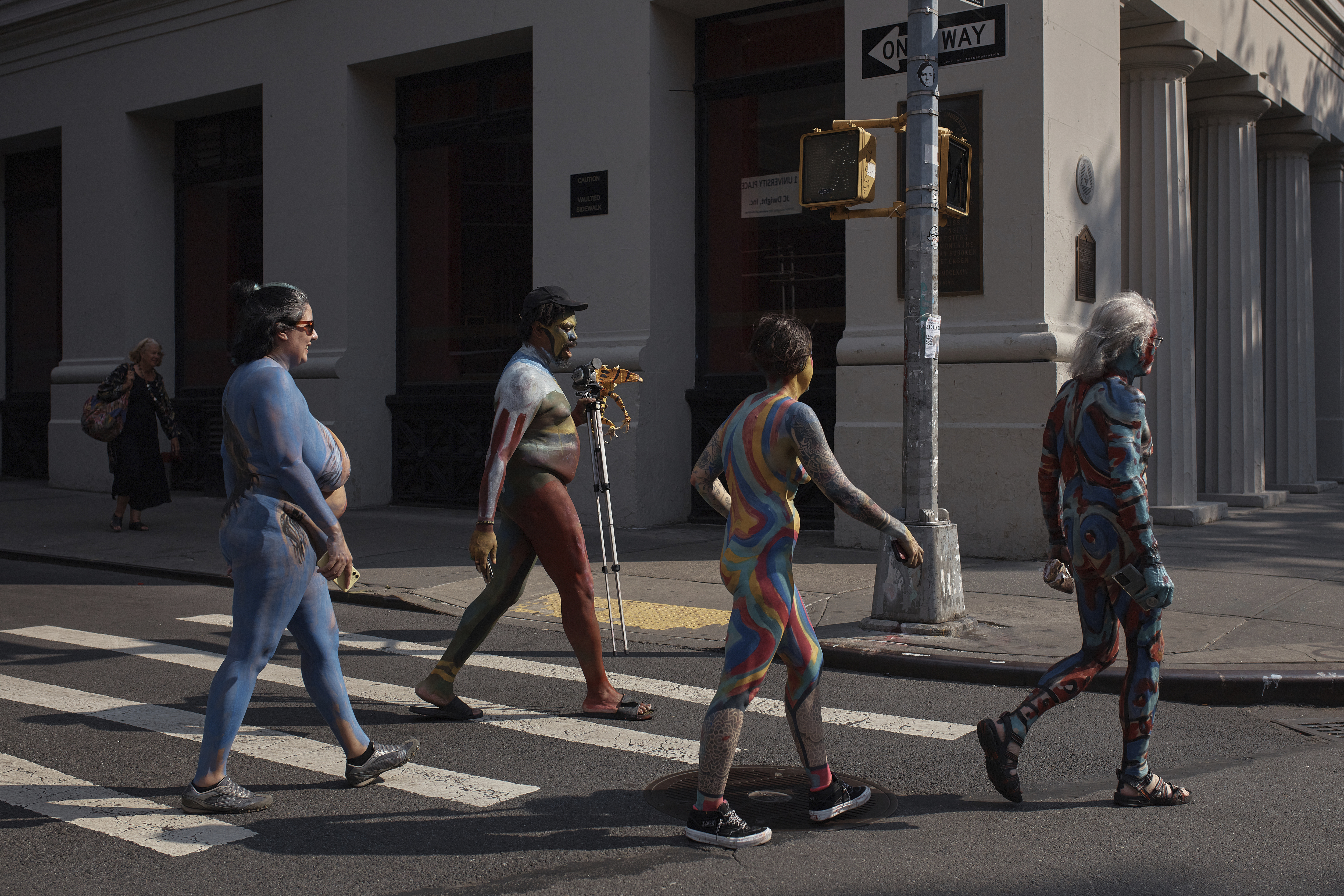 Models painted by an artist cross the street after the Human Connection Arts Annual NYC Bodypainting Day in Union Square Park, Sunday, July 23, 2023, in New York. Sunday’s Bodypainting Day will be the final edition after more than a decade of artists turning nude bodies into works of art. (AP Photo/Andres Kudacki)