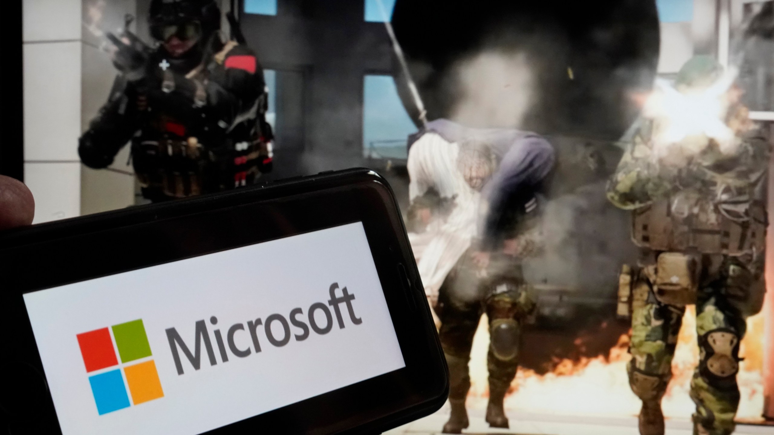 The logo for Microsoft, and a scene from Activision "Call of Duty - Modern Warfare," are shown in this photo, in New York, Wednesday, June 21, 2023. Microsoft reports earnings on Tuesday July 25, 2023. (AP Photo/Richard Drew, File)