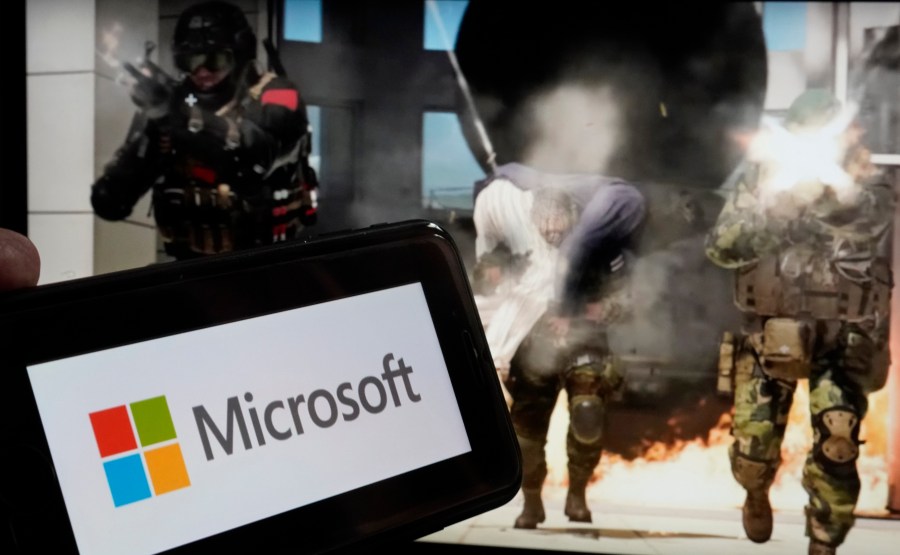 The logo for Microsoft, and a scene from Activision "Call of Duty - Modern Warfare," are shown in this photo, in New York, Wednesday, June 21, 2023. Microsoft reports earnings on Tuesday July 25, 2023. (AP Photo/Richard Drew, File)