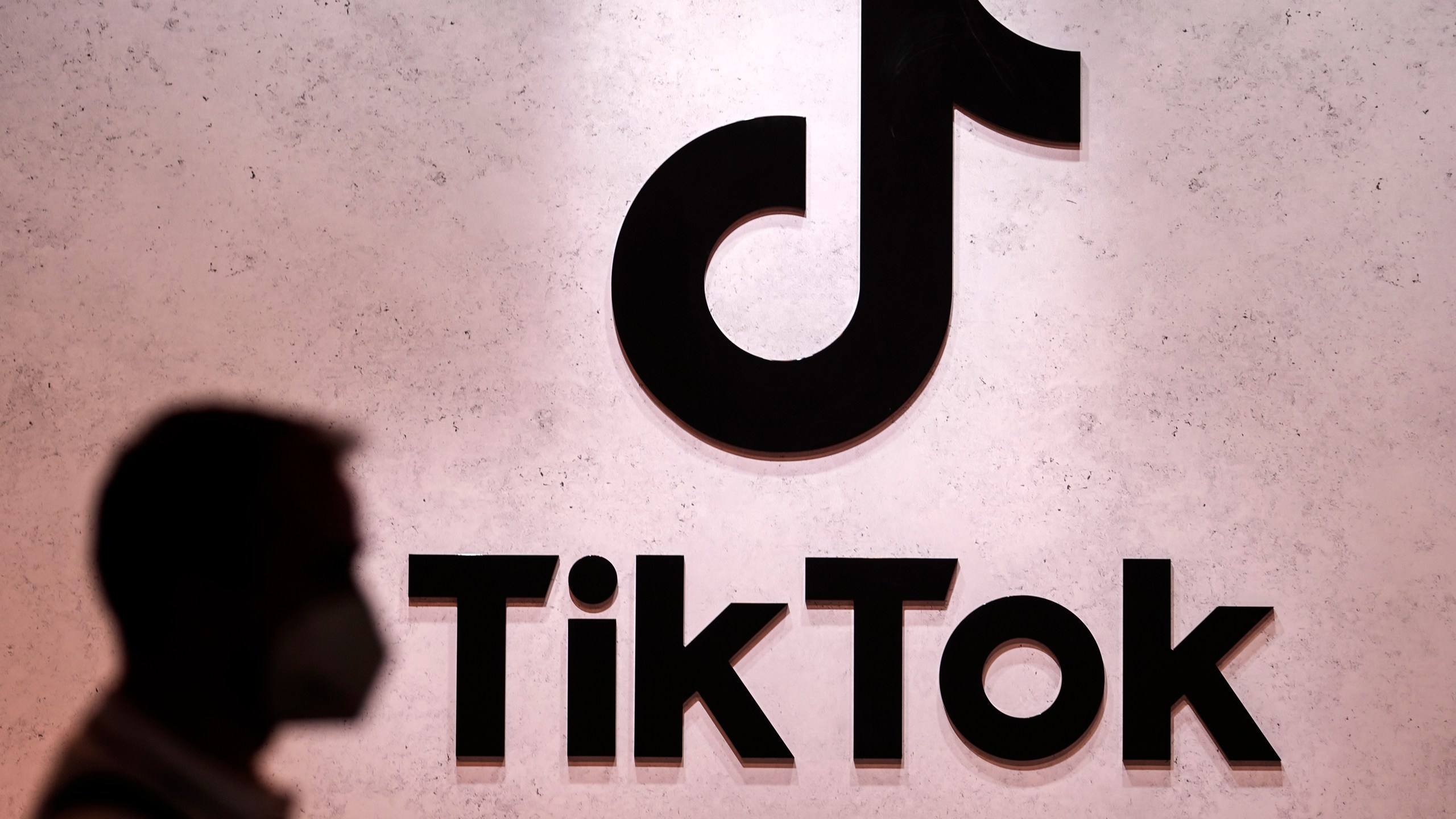 FILE - A visitor passes the TikTok exhibition stand at the Gamescom computer gaming fair in Cologne, Germany, Aug. 25, 2022. The same day Elon Musk abruptly dropped Twitter’s name and bird logo as part of its supposed transition to an “anything app” called X, TikTok impishly announced, late Monday, July 24, 2023, it will begin letting its users post text-based messages. (AP Photo/Martin Meissner, File)