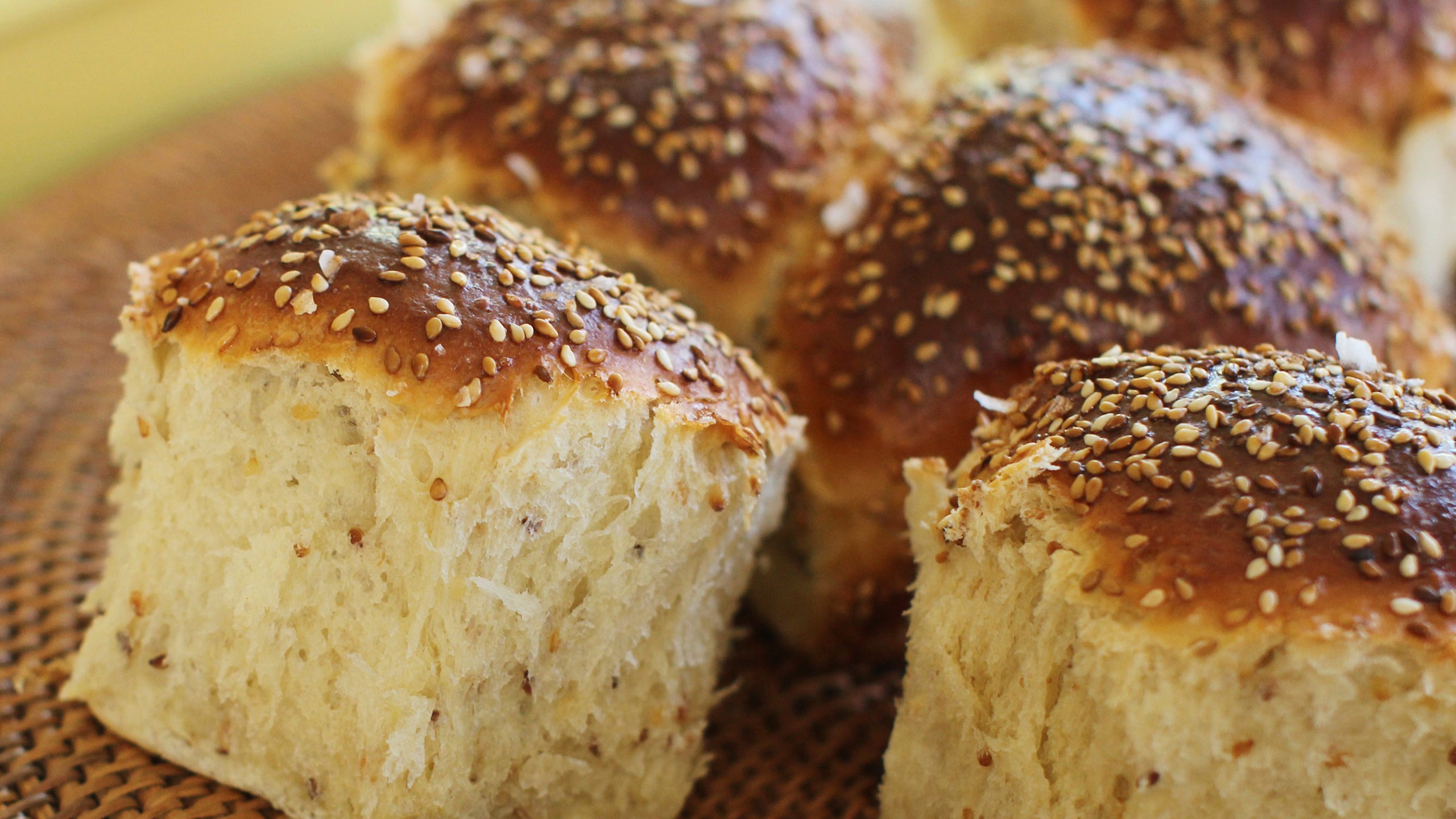 FILE - Sesame dinner rolls sit on a mat in Concord, N.H., on Oct. 12, 2015. Food manufacturers who deliberately add sesame to their products and include it on the labels are not violating a new federal law, the U.S. Food and Drug Administration said Wednesday, July 26, 2023. (AP Photo/Matthew Mead, File)