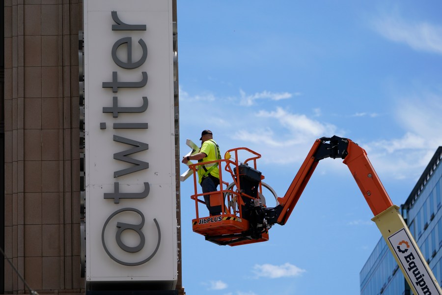 FILE - A workman removes a character from a sign on the Twitter headquarters building in San Francisco, Monday, July 24, 2023. Elon Musk may want to send “tweet” back to the birds, but the ubiquitous term for posting on the site he now calls X is here to stay, at least for now. For one, the word is still plastered all over the website formerly known as Twitter. Write a post, you still need to press a blue button that says “tweet” to publish it. To repost it, you still tap “retweet.” (AP Photo/Godofredo A. Vásquez, File)