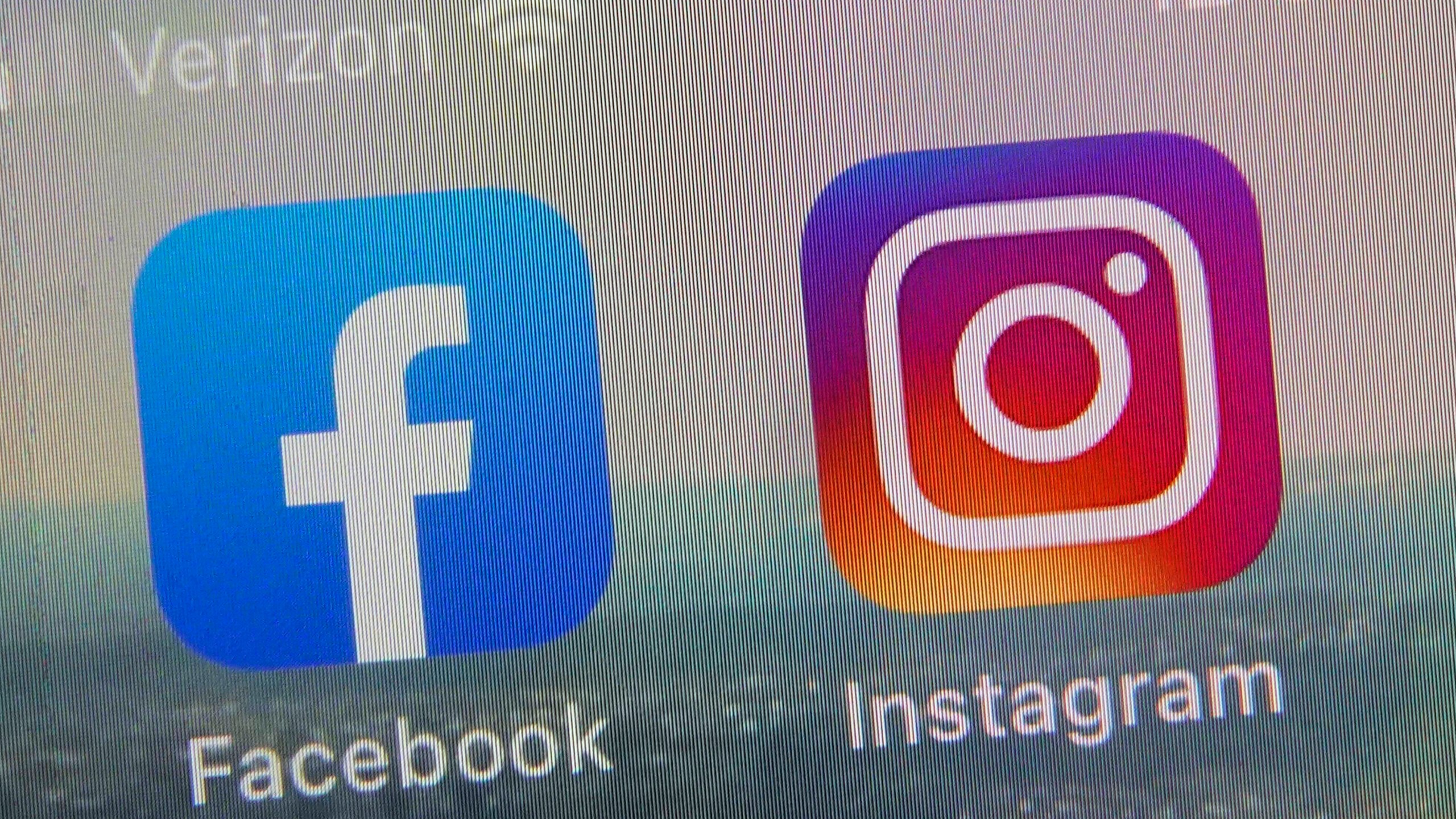 FILE - This photo shows the mobile phone app logos for, from left, Facebook and Instagram in New York, Oct. 5, 2021. A team of some of the world's leading social media researchers has published four studies looking at the relationship between the algorithms used by Facebook and Instagram and America's widening political divide. (AP Photo/Richard Drew, file)