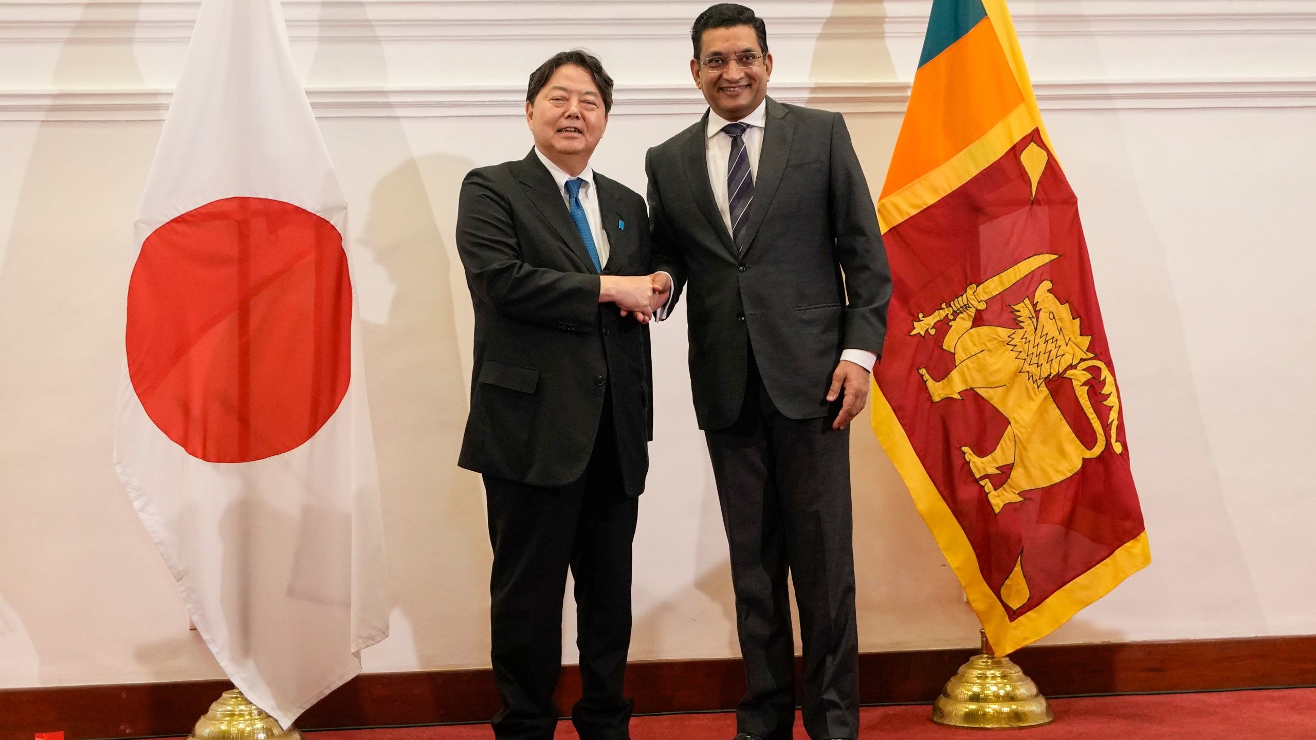 Japanese foreign minister Yoshimasa Hayashi, left, shakes hands with his Sri Lankan counterpart Ali Sabry after their meeting in Colombo, Sri Lanka on Saturday, July 29, 2023. (AP Photo/Eranga Jayawardena)