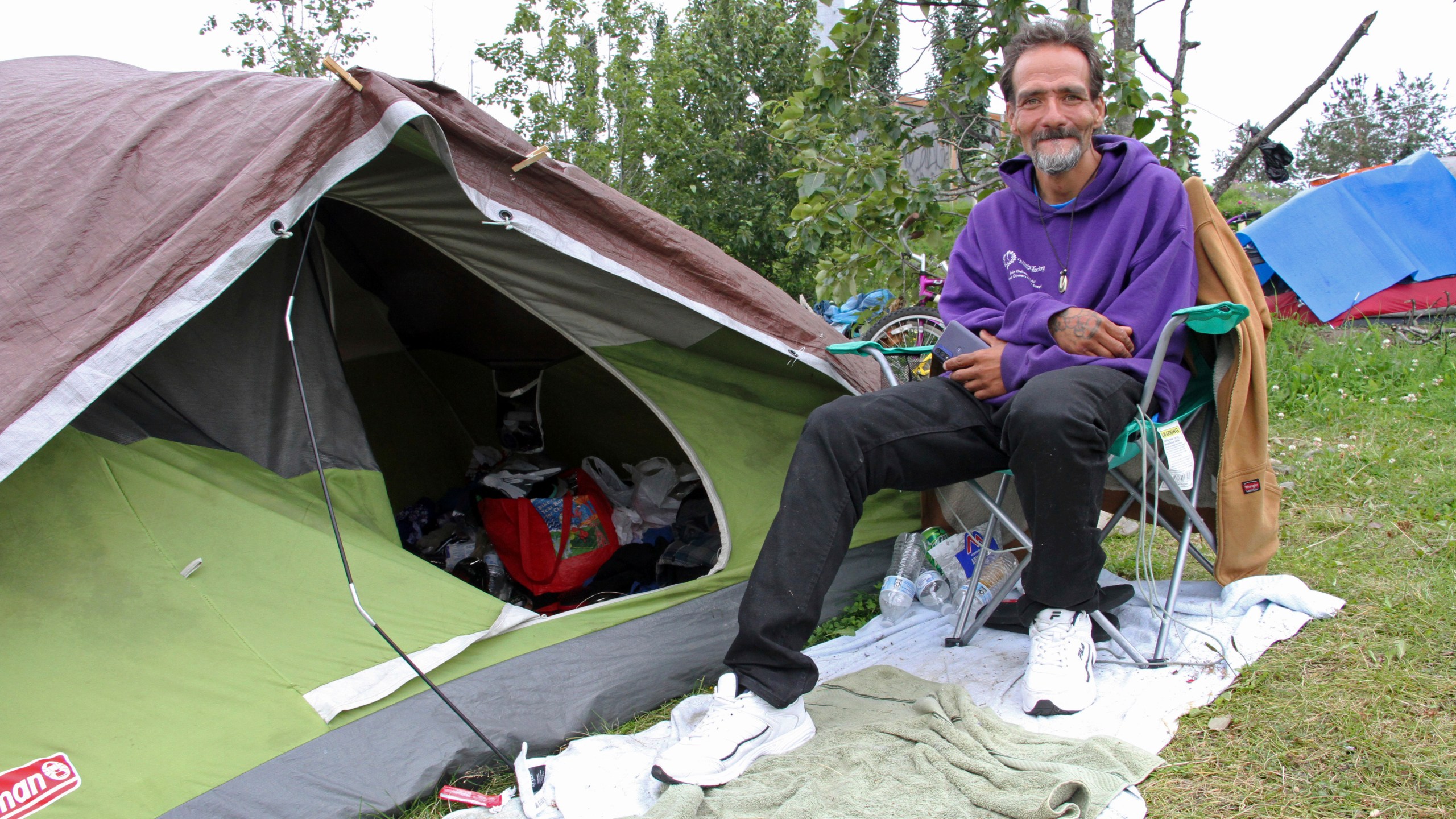 Shawn Steik poses for a photo Wednesday, July, 26, 2023, in downtown Anchorage, Alaska. Steik said he and his wife would likely fly to Seattle if Mayor Dave Bronson's plan announced last week goes forward to buy homeless people plane tickets out of the state or to other Alaska cities to avoid the frigid winter temperatures instead of standing up Anchorage's sports arena as a mass shelter. (AP Photo/Mark Thiessen)