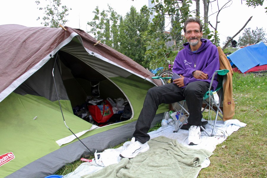 Shawn Steik poses for a photo Wednesday, July, 26, 2023, in downtown Anchorage, Alaska. Steik said he and his wife would likely fly to Seattle if Mayor Dave Bronson's plan announced last week goes forward to buy homeless people plane tickets out of the state or to other Alaska cities to avoid the frigid winter temperatures instead of standing up Anchorage's sports arena as a mass shelter. (AP Photo/Mark Thiessen)