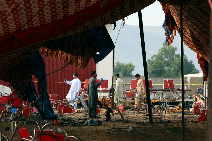 Pakistani investigators inspect at the site of Sunday's suicide bomber attack, in the Bajur district of Khyber Pakhtunkhwa, Pakistan, Monday, July 31, 2023. A suicide bomber blew himself up at a political rally in a former stronghold of militants in northwest Pakistan bordering Afghanistan on Sunday, killing and wounding multiple people in an attack that a senior leader said was meant to weaken Pakistani Islamists. (AP Photo/Mohammad Sajjad)