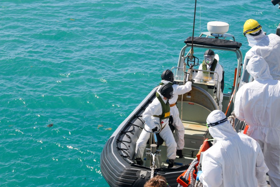 In this photo provided by the Australian Defence Force, sailors from HMAS Brisbane prepare to board a rigid-Hulled inflatable boat to conduct search and rescue operations in the vicinity of Lindeman Island, Australia on Saturday, July 29, 2023, as part of a multi-national and multi-agency search and rescue effort following an Australian Army MRH-90 Taipan helicopter ditching in waters near the island. The helicopter hit the water off Australia's northeast coast with a "catastrophic impact" on Friday and there was no chance that that any of the four air crew would be found alive, officials said on Monday, July 31, 2023. (LSEW Hannah Linsley/ADF via AP)