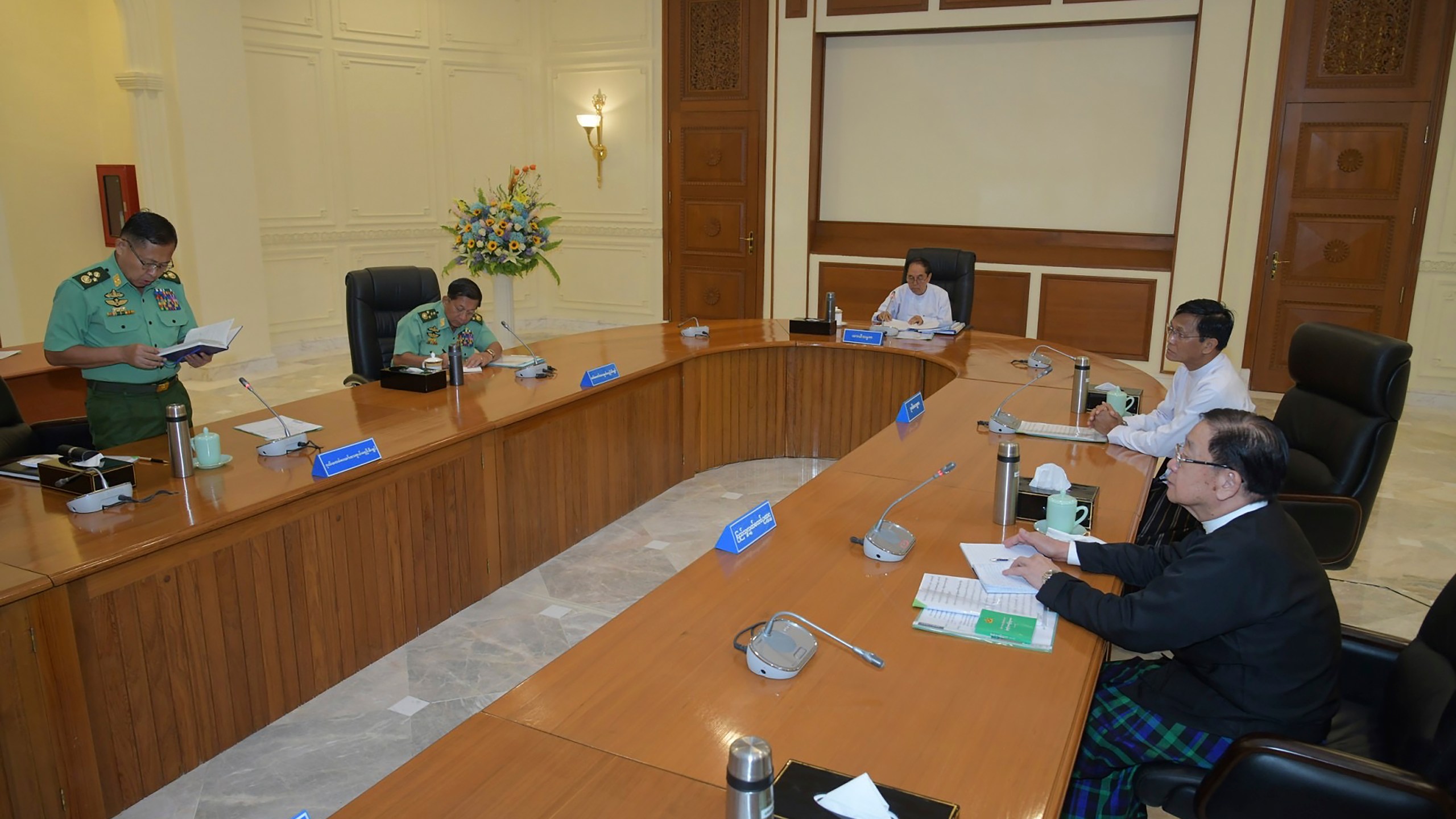 In this photo released from the The Military True News Information Team, Vice Senior Gen. Soe Win, left, deputy chairman of State Administration Council, speaks during a meeting with members the National Defense and Security Council including from left Senior Gen. Min Aung Hlaing, Myint Swe, Pro Temporary President of the military government, Vice President Henry Van Thio, and T Khun Myat, speaker of Union Parliament, Monday, July 31, 2023, in Naypyitaw, Myanmar. Myanmar’s military-controlled government has extended the state of emergency it imposed when the army seized power from an elected government 2 1/2 years ago, forcing a further delay in elections it promised when it took over. (The Military True News Information Team via AP)