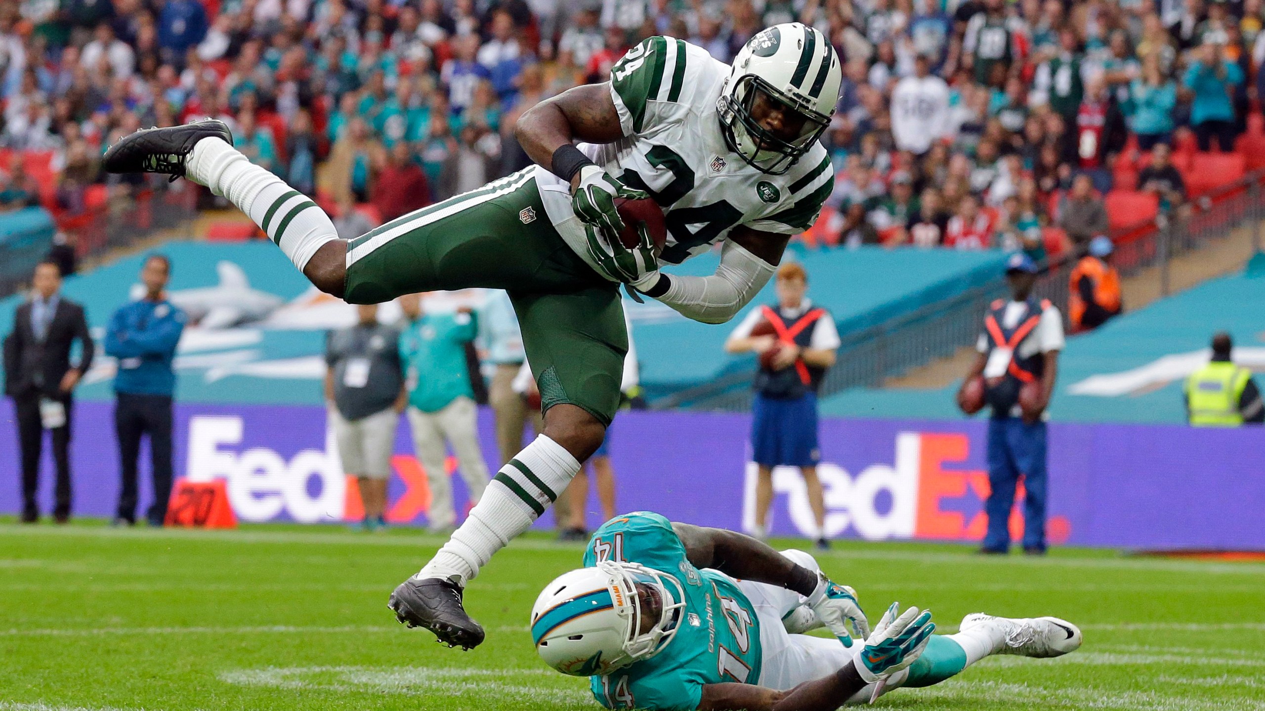 FILE - New York Jets' Darrelle Revis makes an interception over Miami Dolphins' Jarvis Landry during an NFL football game on Oct. 4, 2015, in London. Revis is in the conversation about greatest cornerbacks in NFL history especially after his 2009 season during which he shut down the likes of Randy Moss, Chad Johnson, Andre Johnson, Steve Smith, Terrell Owens, Reggie Wayne and Roddy White. (AP Photo/Matt Dunham, File)