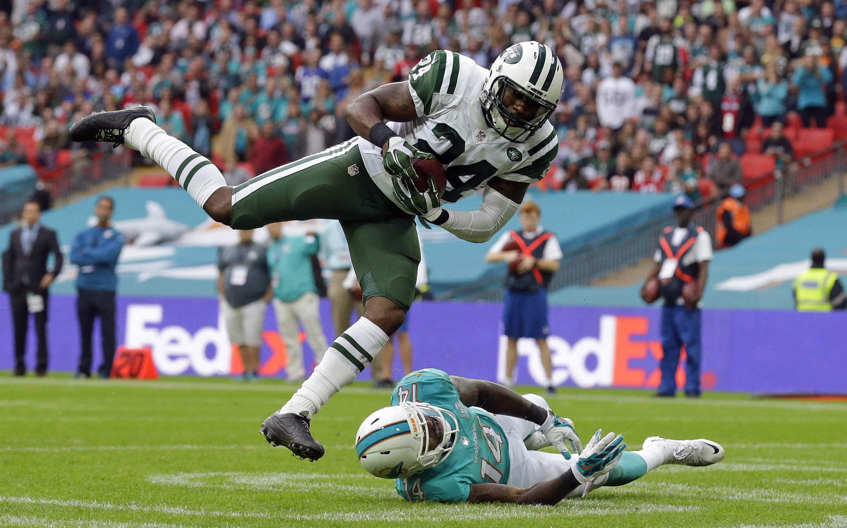 FILE - New York Jets' Darrelle Revis makes an interception over Miami Dolphins' Jarvis Landry during an NFL football game on Oct. 4, 2015, in London. Revis is in the conversation about greatest cornerbacks in NFL history especially after his 2009 season during which he shut down the likes of Randy Moss, Chad Johnson, Andre Johnson, Steve Smith, Terrell Owens, Reggie Wayne and Roddy White. (AP Photo/Matt Dunham, File)