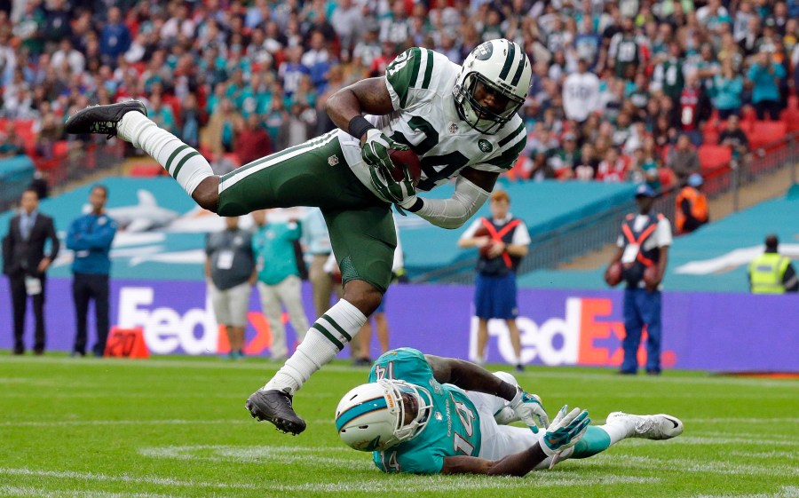 FILE - New York Jets' Darrelle Revis makes an interception over Miami Dolphins' Jarvis Landry during an NFL football game on Oct. 4, 2015, in London. Revis is in the conversation about greatest cornerbacks in NFL history especially after his 2009 season during which he shut down the likes of Randy Moss, Chad Johnson, Andre Johnson, Steve Smith, Terrell Owens, Reggie Wayne and Roddy White. (AP Photo/Matt Dunham, File)