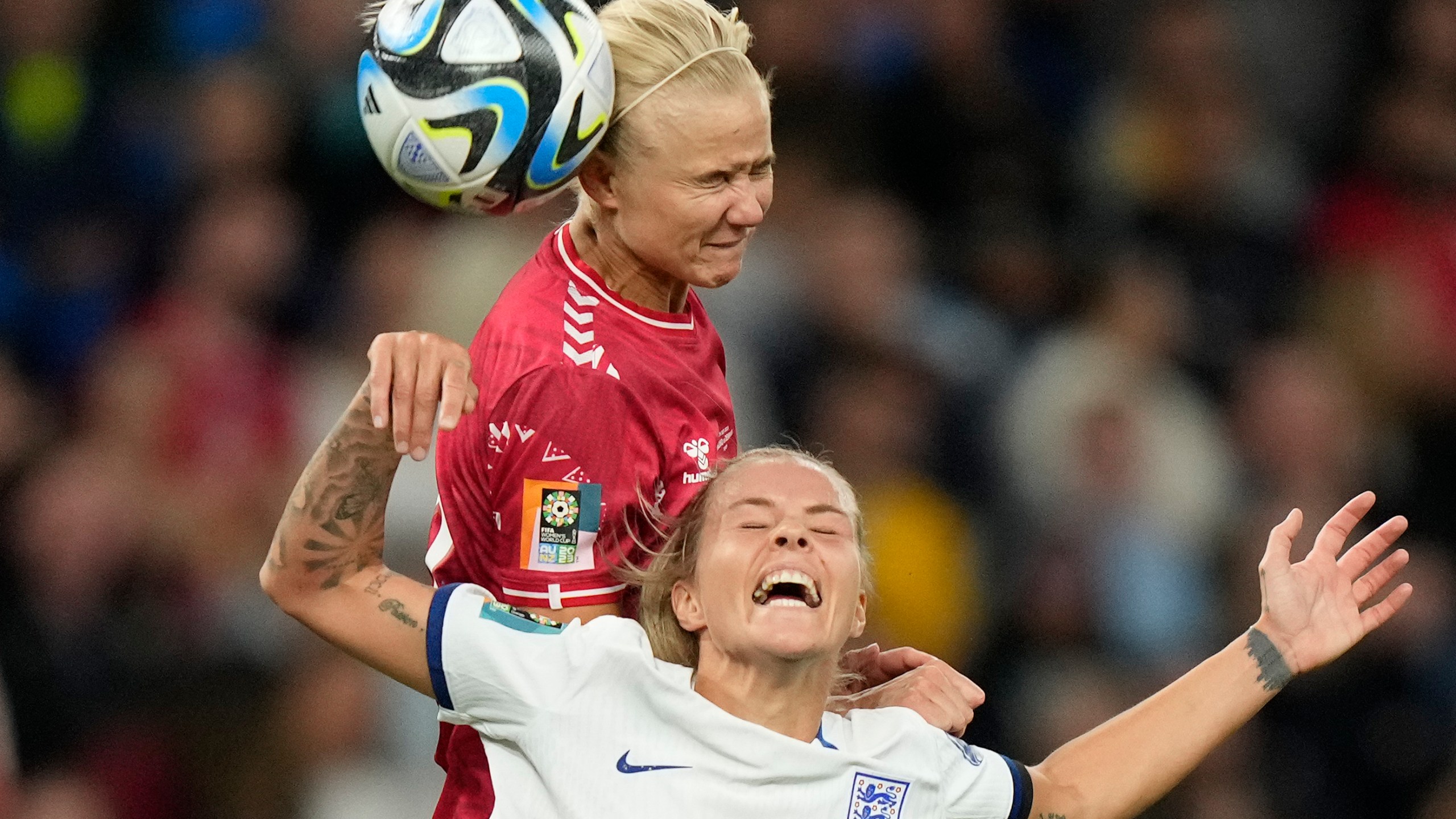 Denmark's Pernille Harder gets above England's Rachel Daly to win a header during the Women's World Cup Group D soccer match between England and Denmark at the Sydney Football Stadium in Sydney, Australia, Friday, July 28, 2023. (AP Photo/Rick Rycroft)