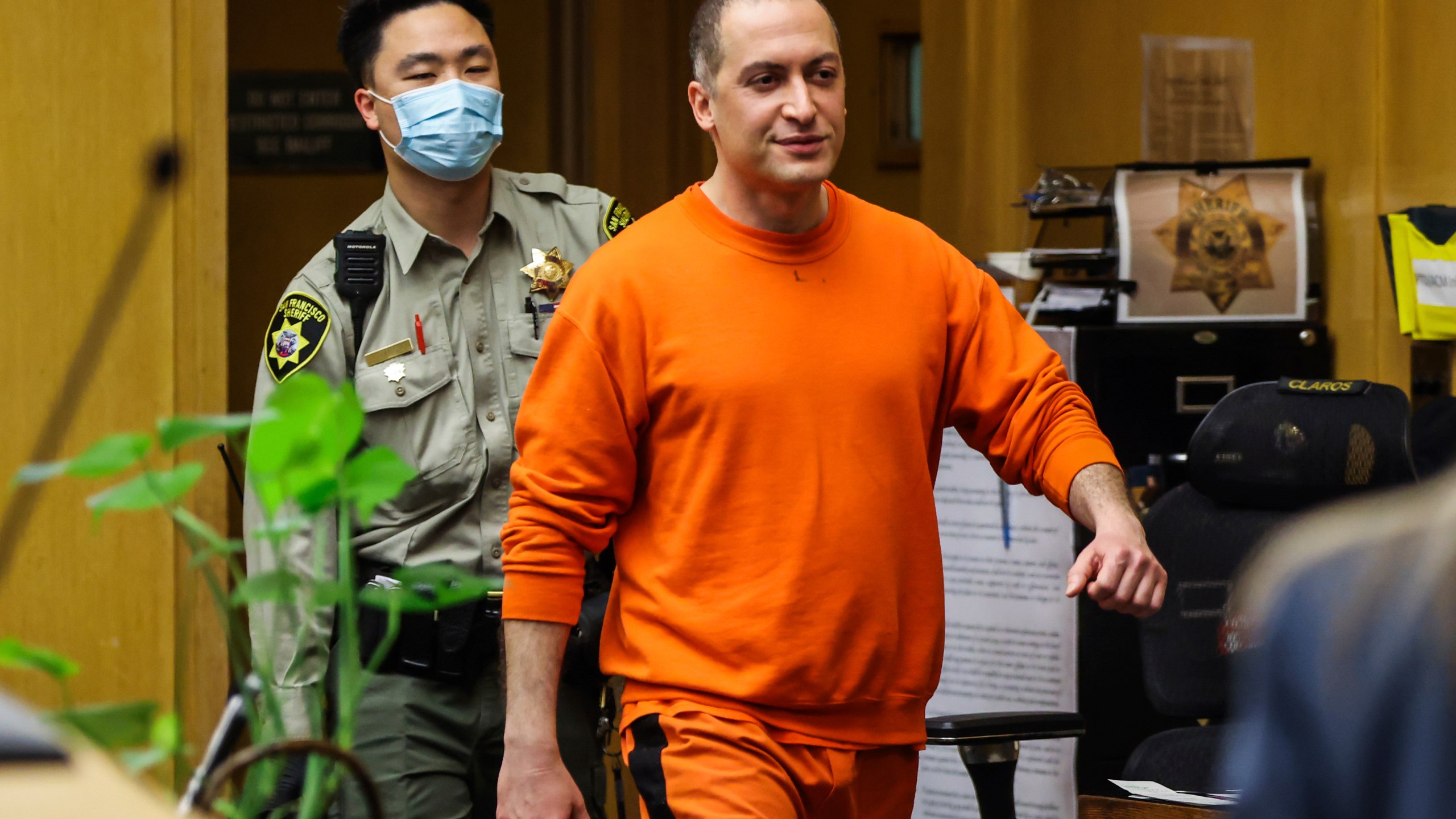 FILE -Nima Momeni, the man charged in the fatal stabbing of Cash App founder Bob Lee, makes his way into the courtroom for his arraignment in San Francisco on May 2, 2023. The San Francisco prosecutor's office starts laying out its murder case against a tech consultant charged in the stabbing death of Cash App founder Bob Lee. The preliminary hearing started Monday, July 31, 2023, before a judge who will decide if there's enough evidence to go to trial. (Gabrielle Lurie/San Francisco Chronicle via AP, Pool, File)