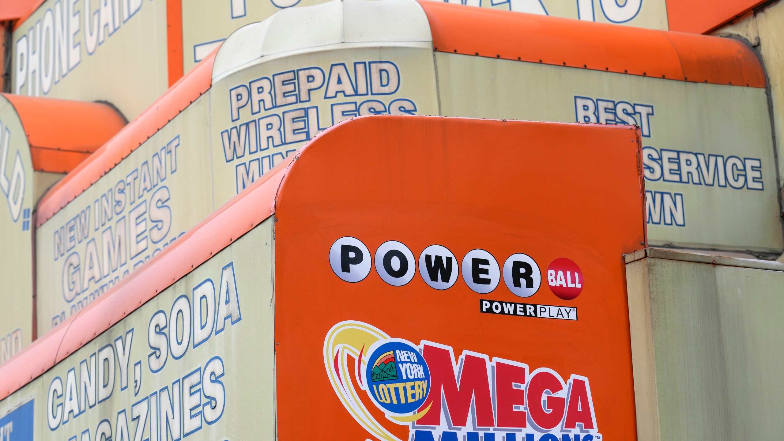 FILE - The awnings of a store advertise the sale of lottery tickets, including Mega Millions, Wednesday, Jan. 11, 2023, in New York. The Mega Millions prize has grown to an estimated $1.05 billion for the Tuesday, Aug. 1, 2023, drawing. (AP Photo/Seth Wenig, File)