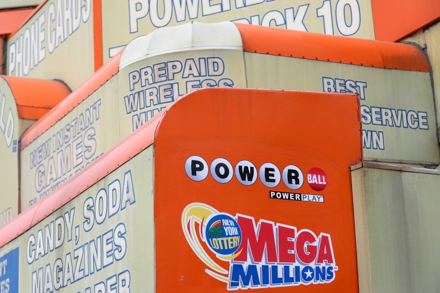 FILE - The awnings of a store advertise the sale of lottery tickets, including Mega Millions, Wednesday, Jan. 11, 2023, in New York. The Mega Millions prize has grown to an estimated $1.05 billion for the Tuesday, Aug. 1, 2023, drawing. (AP Photo/Seth Wenig, File)