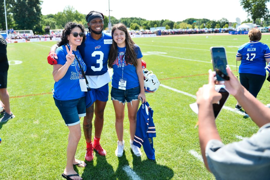 Buffalo Bills safety Damar Hamlin poses for a photo with fans after practice at the NFL football team's training camp in Pittsford, N.Y., Sunday, July 30, 2023. (AP Photo/Adrian Kraus)