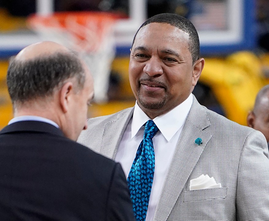 FILE - NBA analyst Mark Jackson, right, talks with Jeff Van Gundy, left, and others before Game 4 of basketball's NBA Finals between the Golden State Warriors and the Toronto Raptors in Oakland, Calif., June 7, 2019. Add Jackson to the long list of ESPN reporters and commentators who have been laid off over the past five weeks. Jackson was let go on Monday, July 31, 2023, with two years remaining on his contract. (AP Photo/Tony Avelar, File)