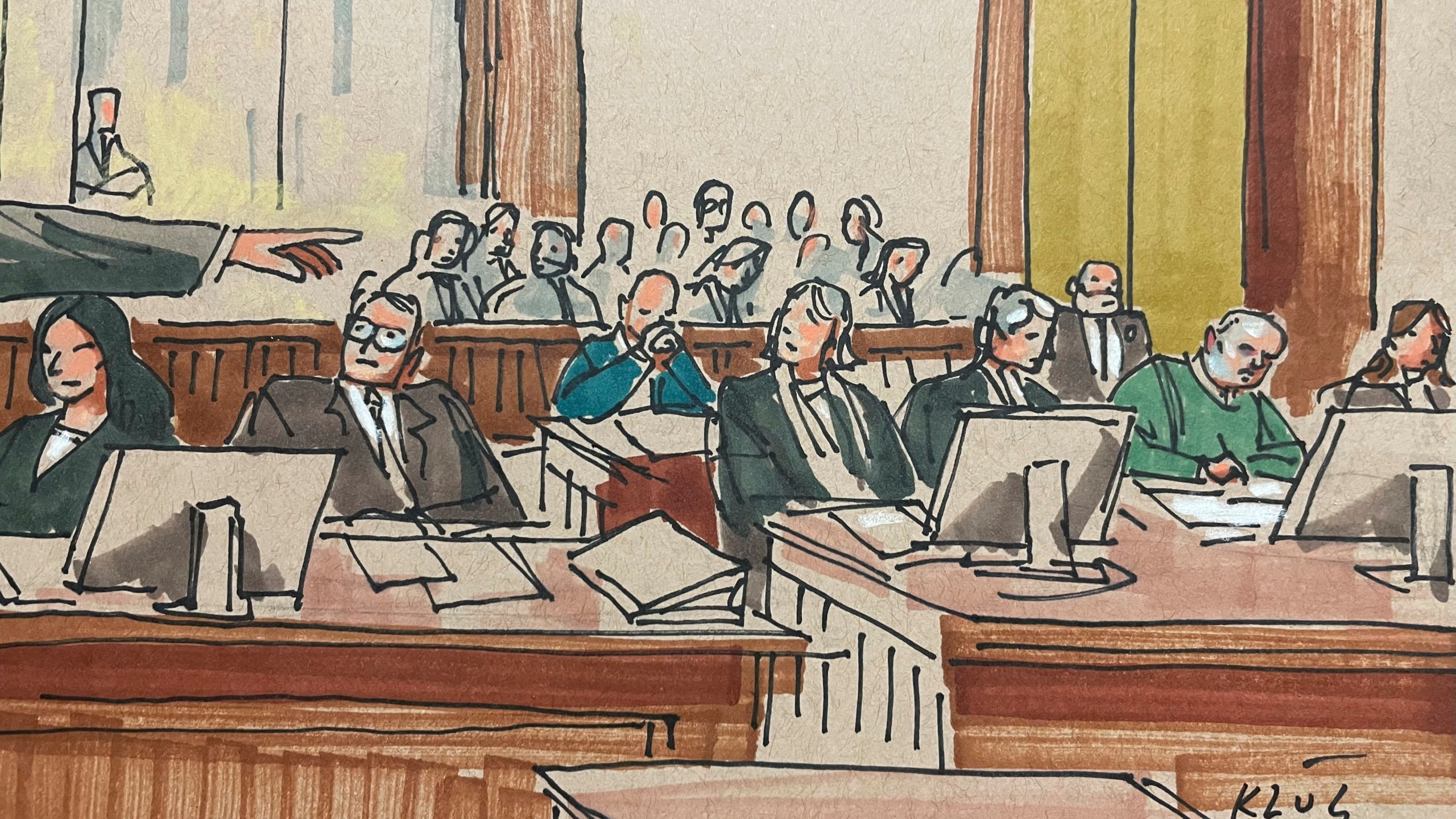 U.S. Attorney Eric Olshan, hand at left, argues before a federal jury that 2018 Pittsburgh synagogue attack defendant Robert Bowers should receive the death penalty, Monday July 31, 2023. Bowers, wearing green, was previously found guilty of killing 11 people in the deadliest antisemitic attack in U.S. history. (Dave Klug via AP)