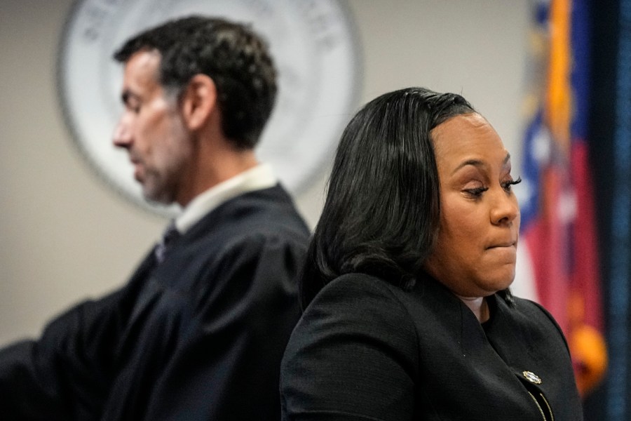 FILE - Fulton County District Attorney Fani Willis, right, and Fulton County Superior Court Judge Robert McBurney speak in the Fulton county courthouse, Tuesday, July 11, 2023, in Atlanta. Lawyers for former President Donald Trump are asking Georgia's highest court to prevent the district attorney who’s been investigating his actions in the wake of the 2020 election from prosecuting him. (AP Photo/Brynn Anderson, File)