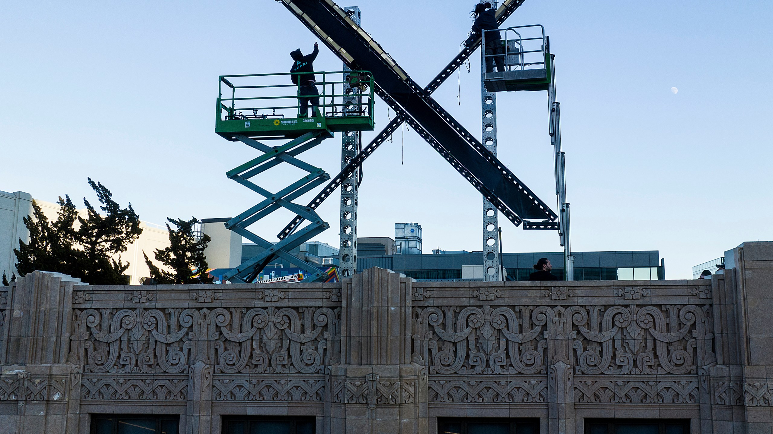 Workers install lighting on an "X" sign atop the downtown San Francisco building that housed what was formally known as Twitter, now rebranded X by owner Elon Musk, Friday, July 28, 2023. (AP Photo/Noah Berger)