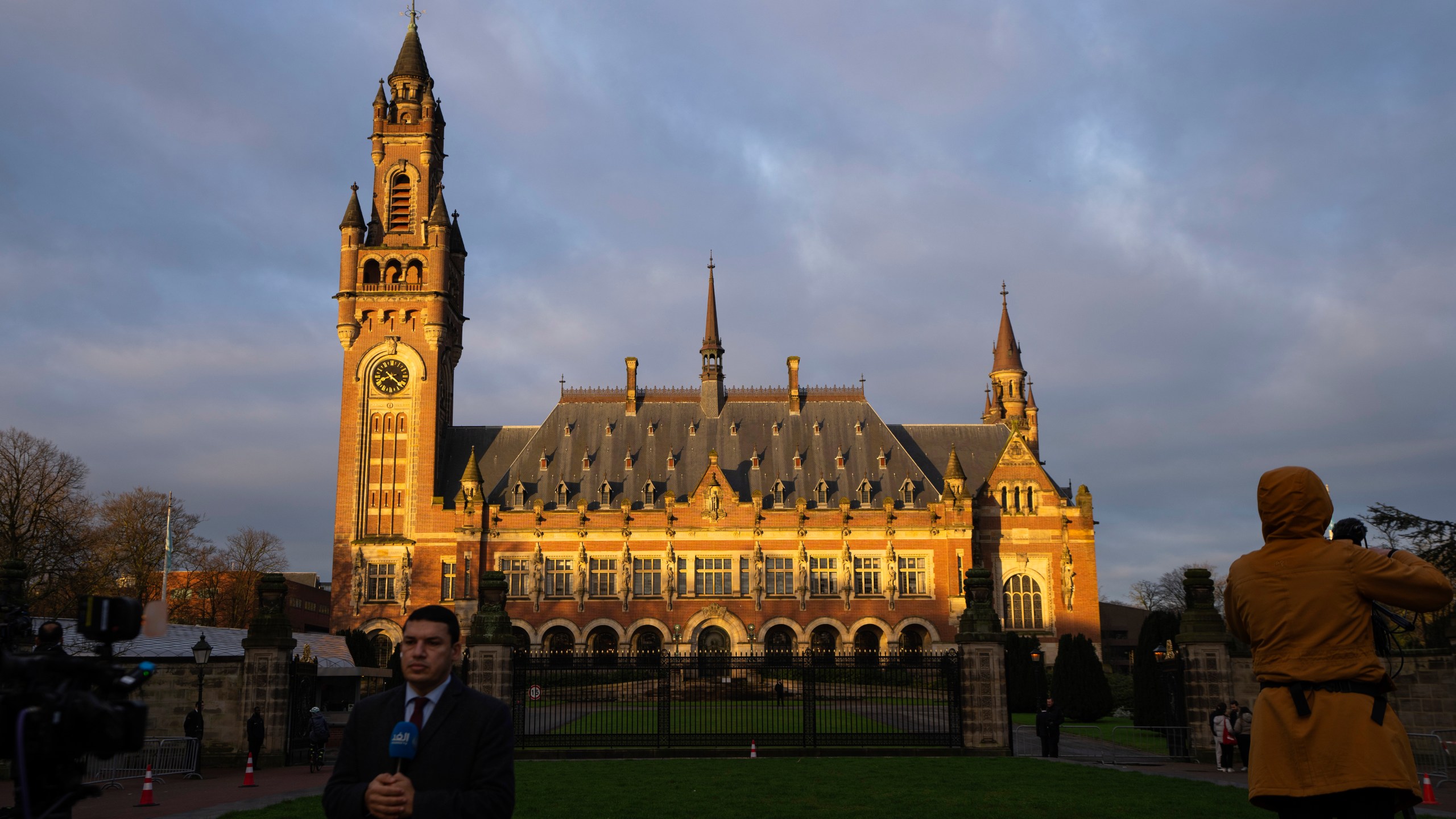 Journalists are seen outside the Peace Palace, housing the United Nations' top court, in The Hague, Netherlands, Monday, Feb. 19, 2024. Historic hearings are opening on Monday at the United Nations’ top court into the legality of Israel’s 57-year occupation of lands sought for a Palestinian state. (AP Photo/Peter Dejong)