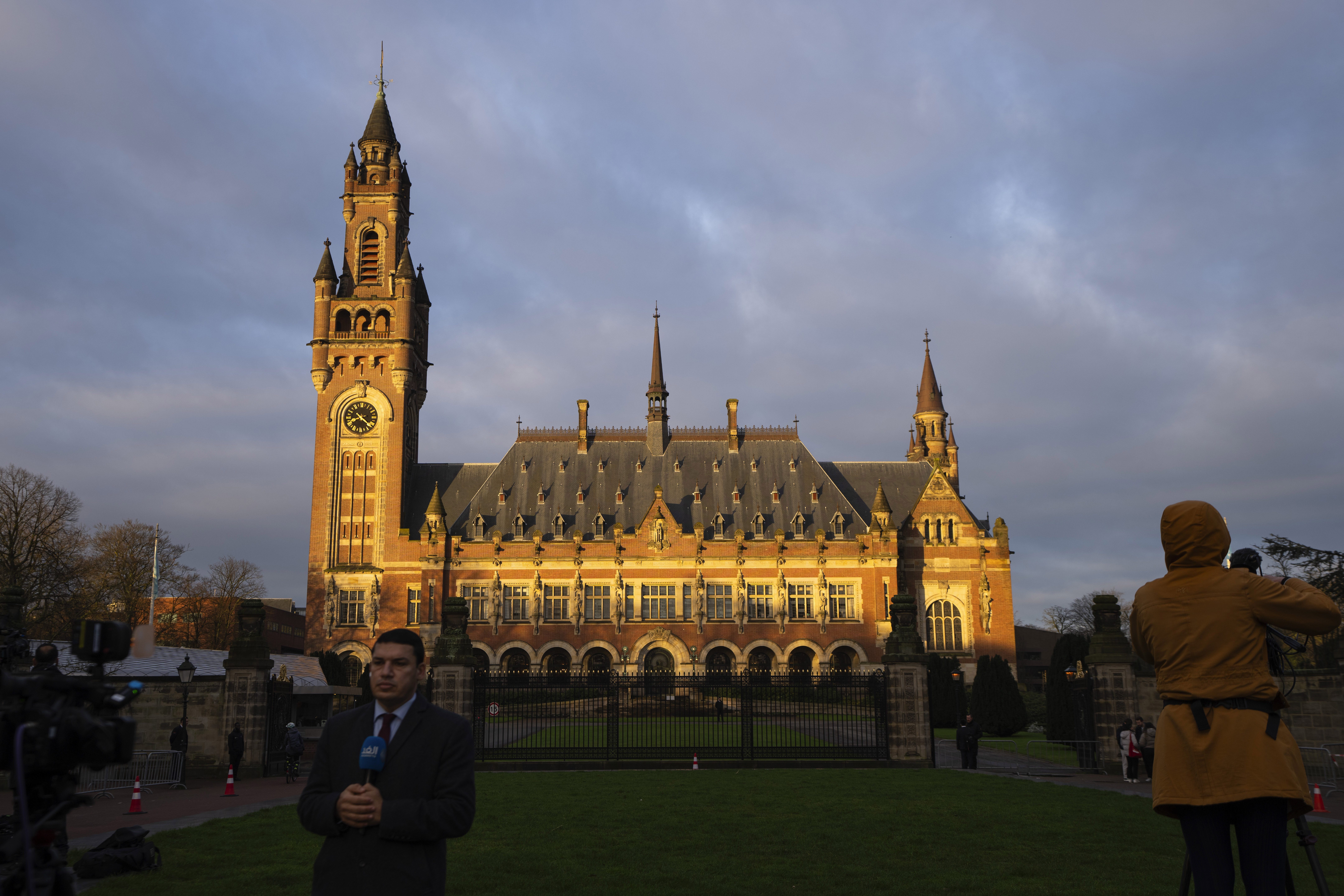 Journalists are seen outside the Peace Palace, housing the United Nations' top court, in The Hague, Netherlands, Monday, Feb. 19, 2024. Historic hearings are opening on Monday at the United Nations’ top court into the legality of Israel’s 57-year occupation of lands sought for a Palestinian state. (AP Photo/Peter Dejong)