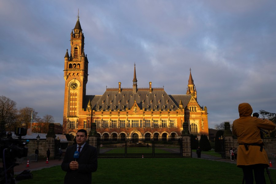 Journalists are seen outside the Peace Palace, housing the United Nations' top court, in The Hague, Netherlands, Monday, Feb. 19, 2024. Historic hearings are opening on Monday at the United Nations’ top court into the legality of Israel’s 57-year occupation of lands sought for a Palestinian state. (AP Photo/Peter Dejong)