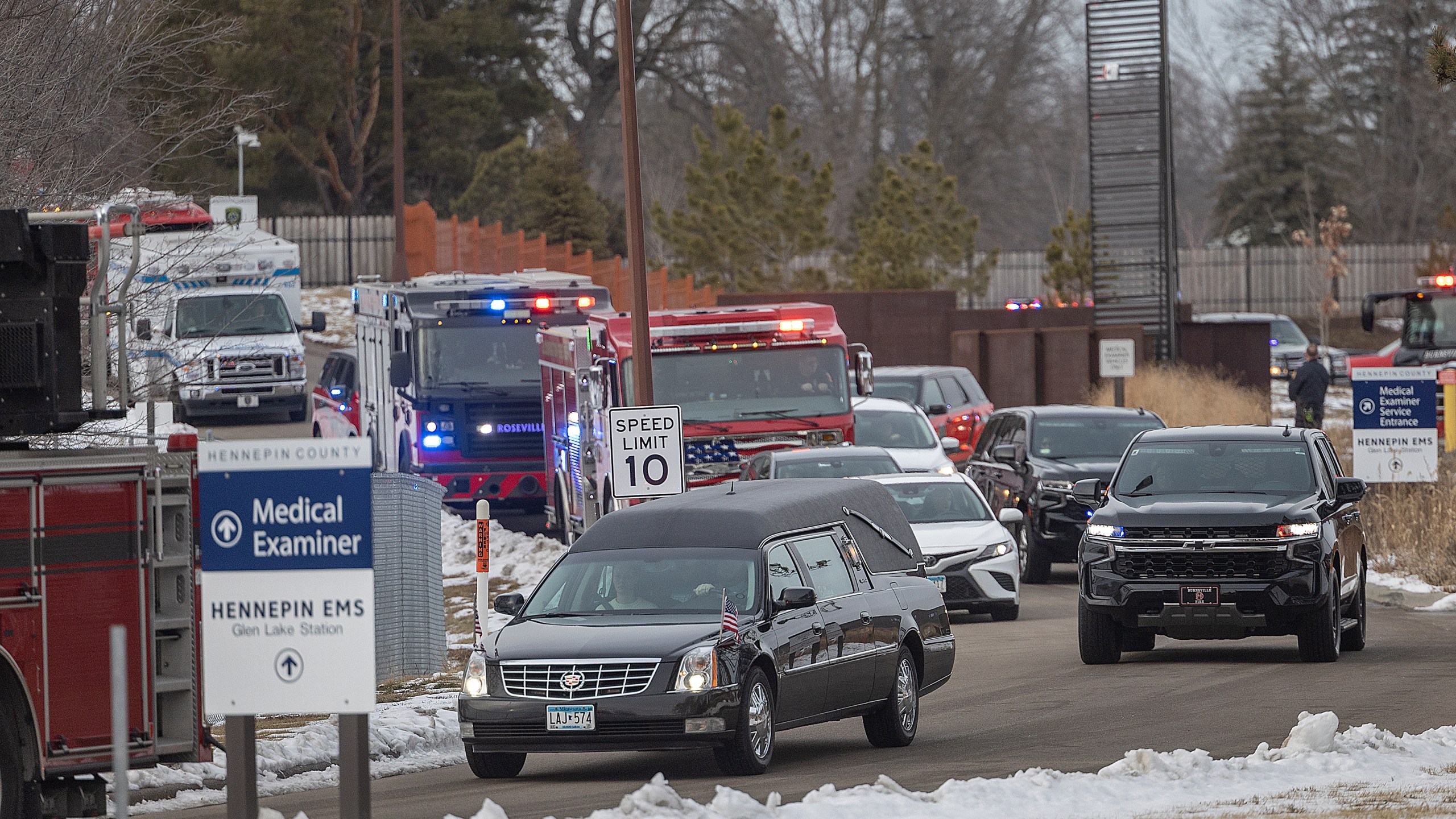 The hearse bearing the body of Burnsville firefighter and paramedic Adam Finseth leaves the Hennepin County Medical Examiner in Minnetonka, Minn., Monday, Feb. 19, 2024. Finseth and two police officers were shot and killed early Sunday and a third officer was injured at a suburban Minneapolis home in an exchange of gunfire while responding to a call involving an armed man who had barricaded himself inside with family. (Elizabeth Flores/Star Tribune via AP)