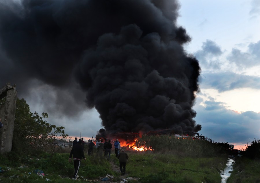 Black smoke and flames rise from a burning warehouse, attacked by Israeli strikes, at an industrial district, in the southern coastal town of Ghazieh, Lebanon, Monday, Feb. 19, 2024. Israel's air force carried out at least two airstrikes near the southern port city of Sidon in one of the largest attacks near a major city, state media reported. (AP Photo/Mohammed Zaatari)