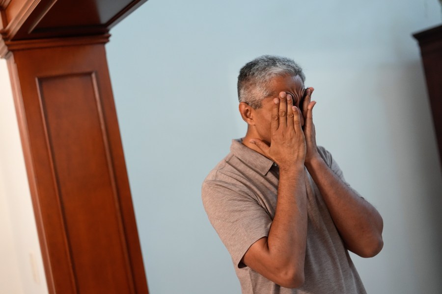 Surgeon General Dr. Vivek Murthy rubs his temples as he transitions from work to family life, during a visit to his parents' home, Tuesday, July 16, 2024, near Miami, Fla. (AP Photo/Rebecca Blackwell)