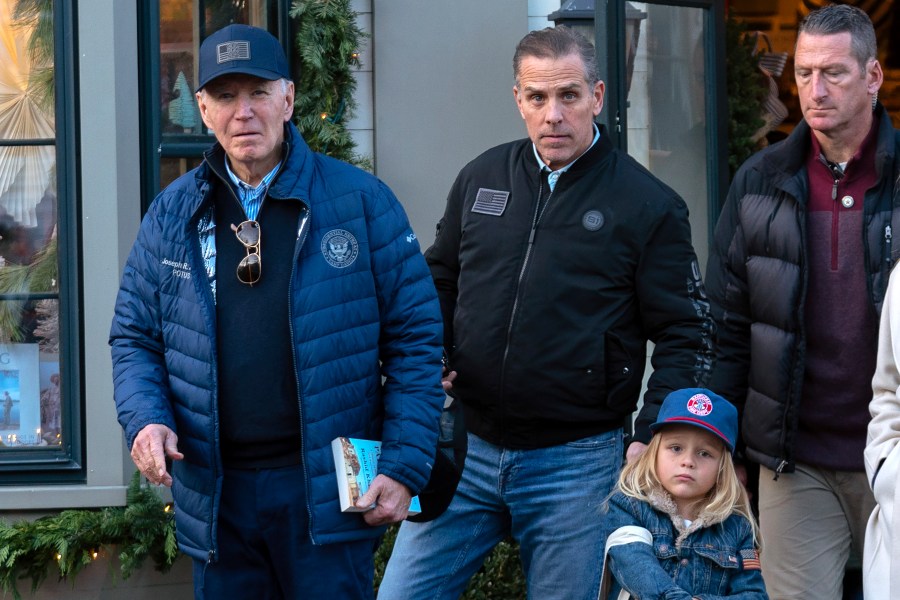 President Joe Biden accompanied by his son Hunter Biden and his grandson Beau leave a book store as they walk in downtown Nantucket Mass., Friday, Nov. 29, 2024. (AP Photo/Jose Luis Magana)