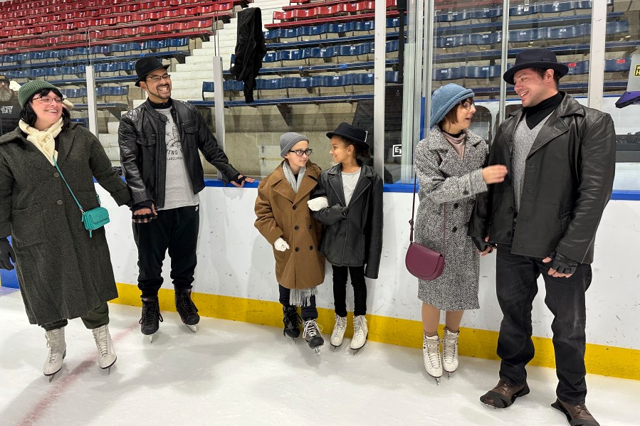 Contestants of the Rocky and Adrian look-alike stand on Penn Ice Rink during RockyFest in Philadelphia, Friday, Dec. 6, 2024. (AP Photo/Tassanee Vejpongsa)