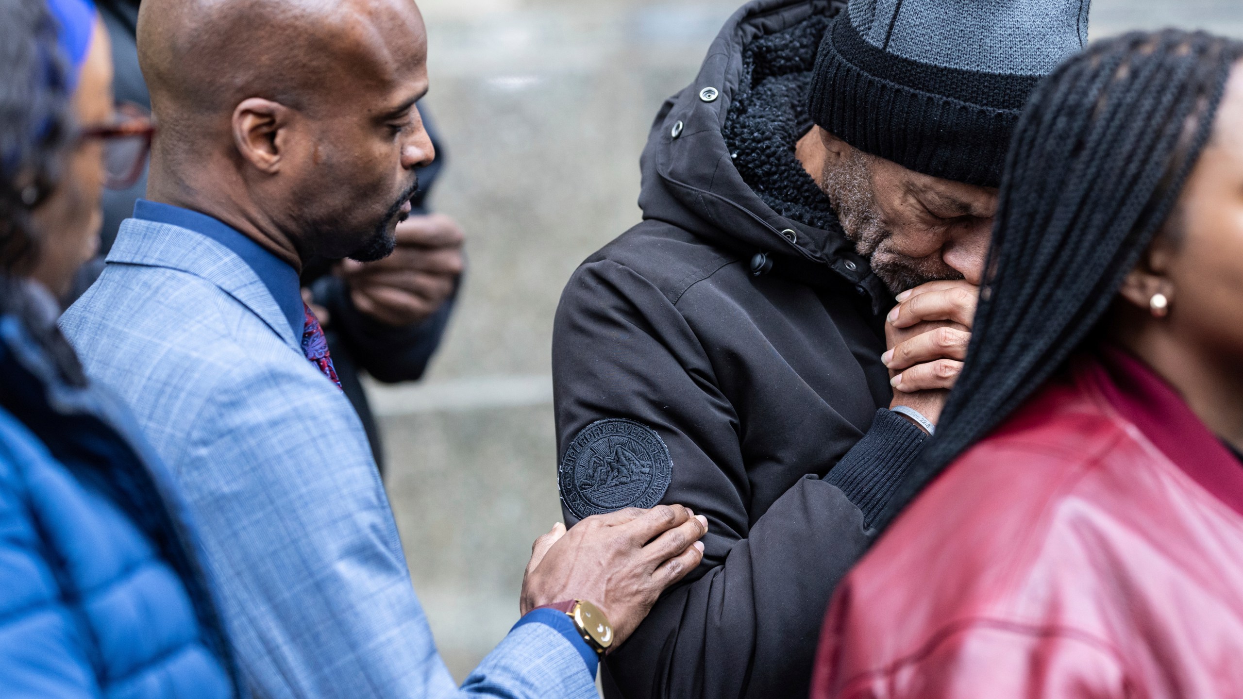 CORRECTS NAME SPELLING Attorney Donte Mills, left, comforts an emotional Andre Zachery, father of Jordan Neely, outside the criminal court, Monday, Dec. 9, 2024, in New York. (AP Photo/Stefan Jeremiah)