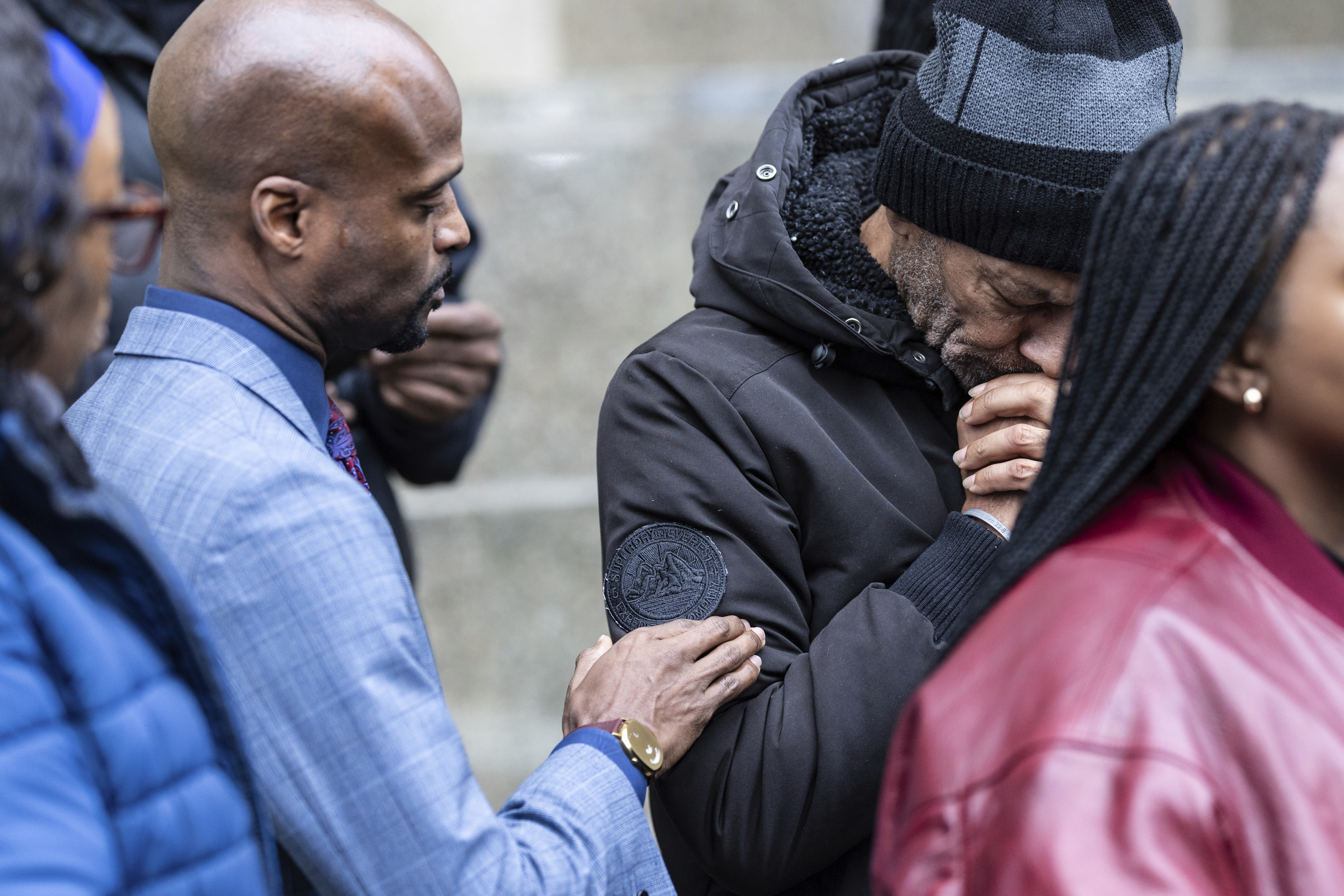 CORRECTS NAME SPELLING Attorney Donte Mills, left, comforts an emotional Andre Zachery, father of Jordan Neely, outside the criminal court, Monday, Dec. 9, 2024, in New York. (AP Photo/Stefan Jeremiah)