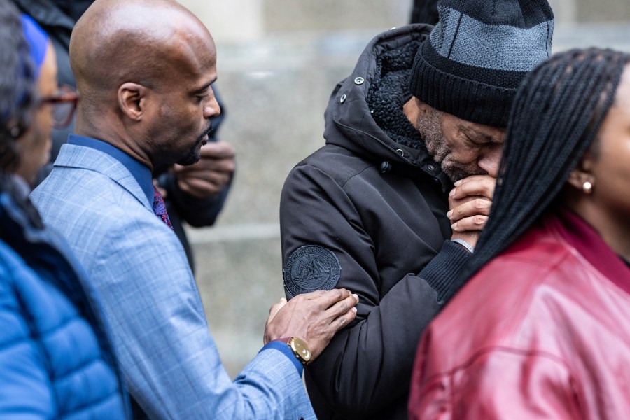 CORRECTS NAME SPELLING Attorney Donte Mills, left, comforts an emotional Andre Zachery, father of Jordan Neely, outside the criminal court, Monday, Dec. 9, 2024, in New York. (AP Photo/Stefan Jeremiah)