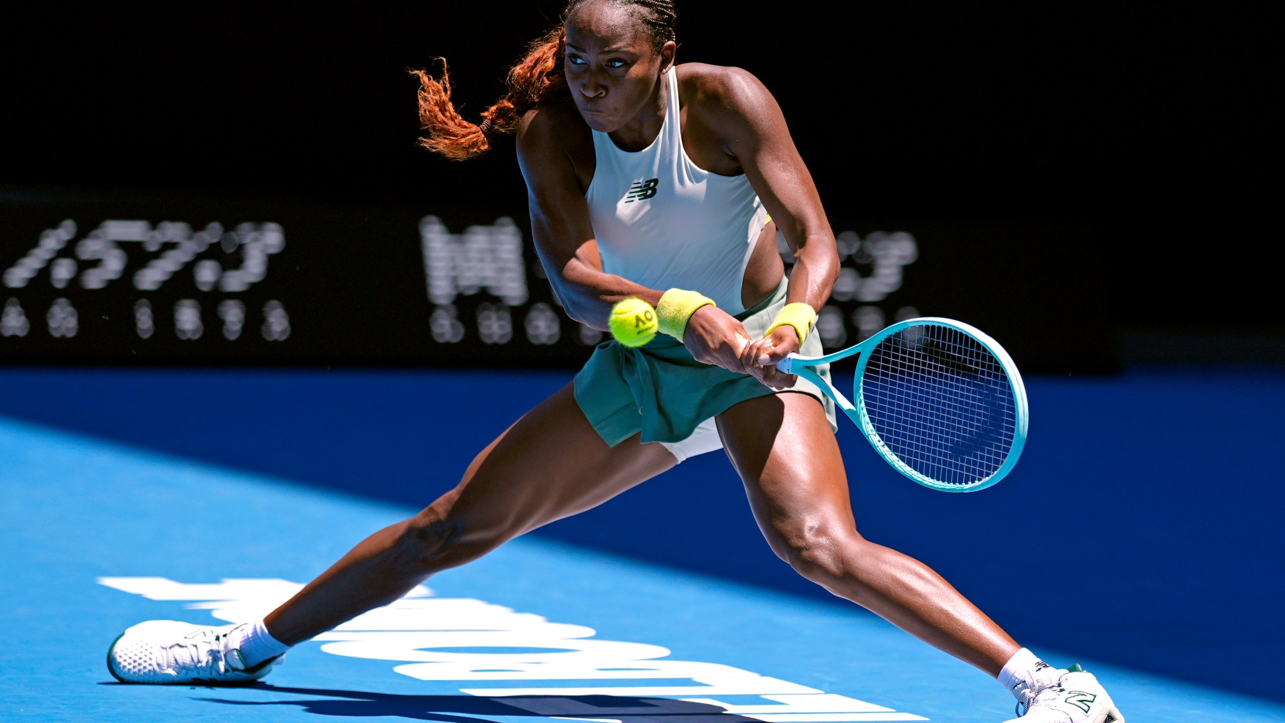 Coco Gauff of the U.S. plays a backhand return to Sofia Kenin of the U.S. during their first round match at the Australian Open tennis championship in Melbourne, Australia, Monday, Jan. 13, 2025. (AP Photo/Asanka Brendon Ratnayake)