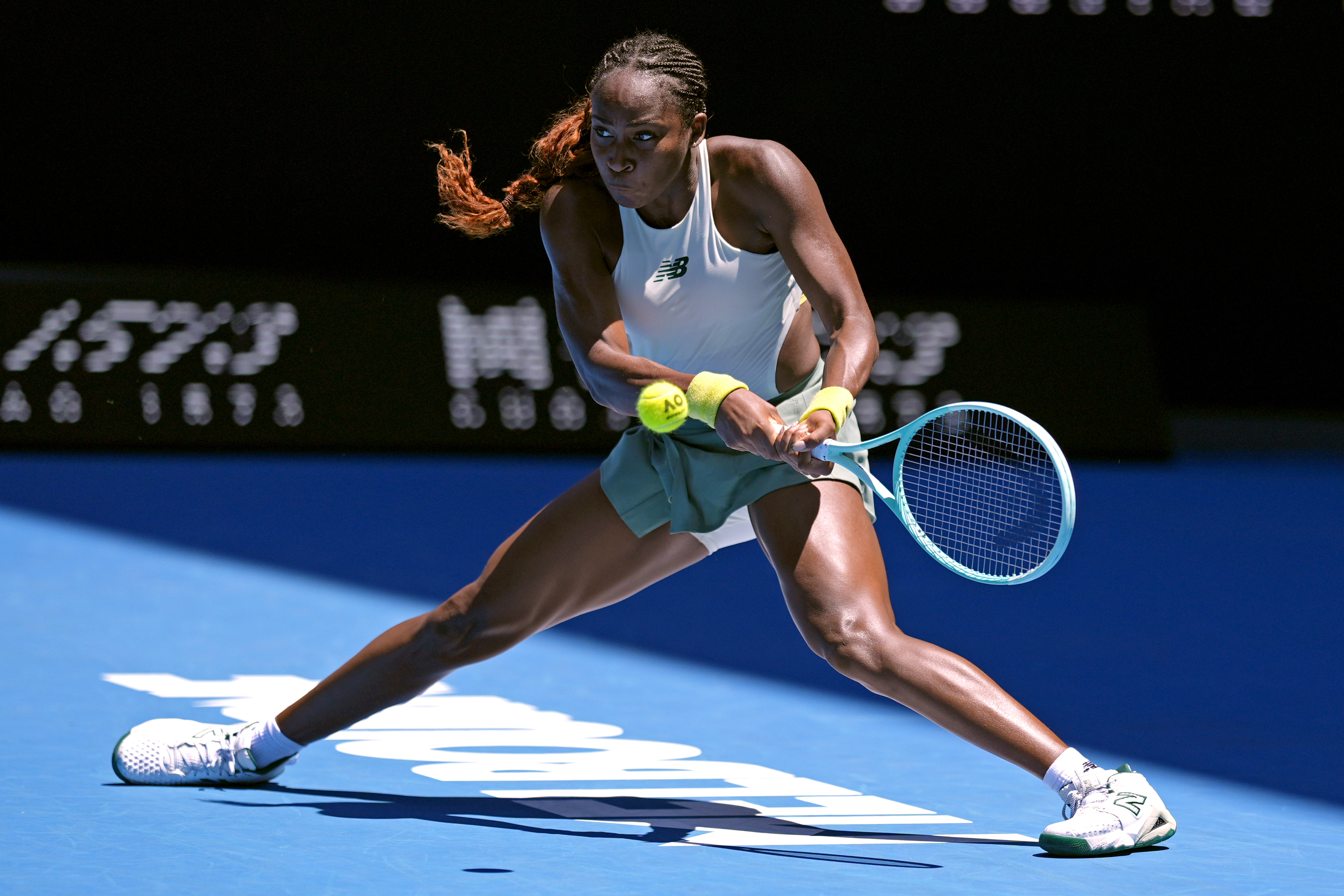 Coco Gauff of the U.S. plays a backhand return to Sofia Kenin of the U.S. during their first round match at the Australian Open tennis championship in Melbourne, Australia, Monday, Jan. 13, 2025. (AP Photo/Asanka Brendon Ratnayake)