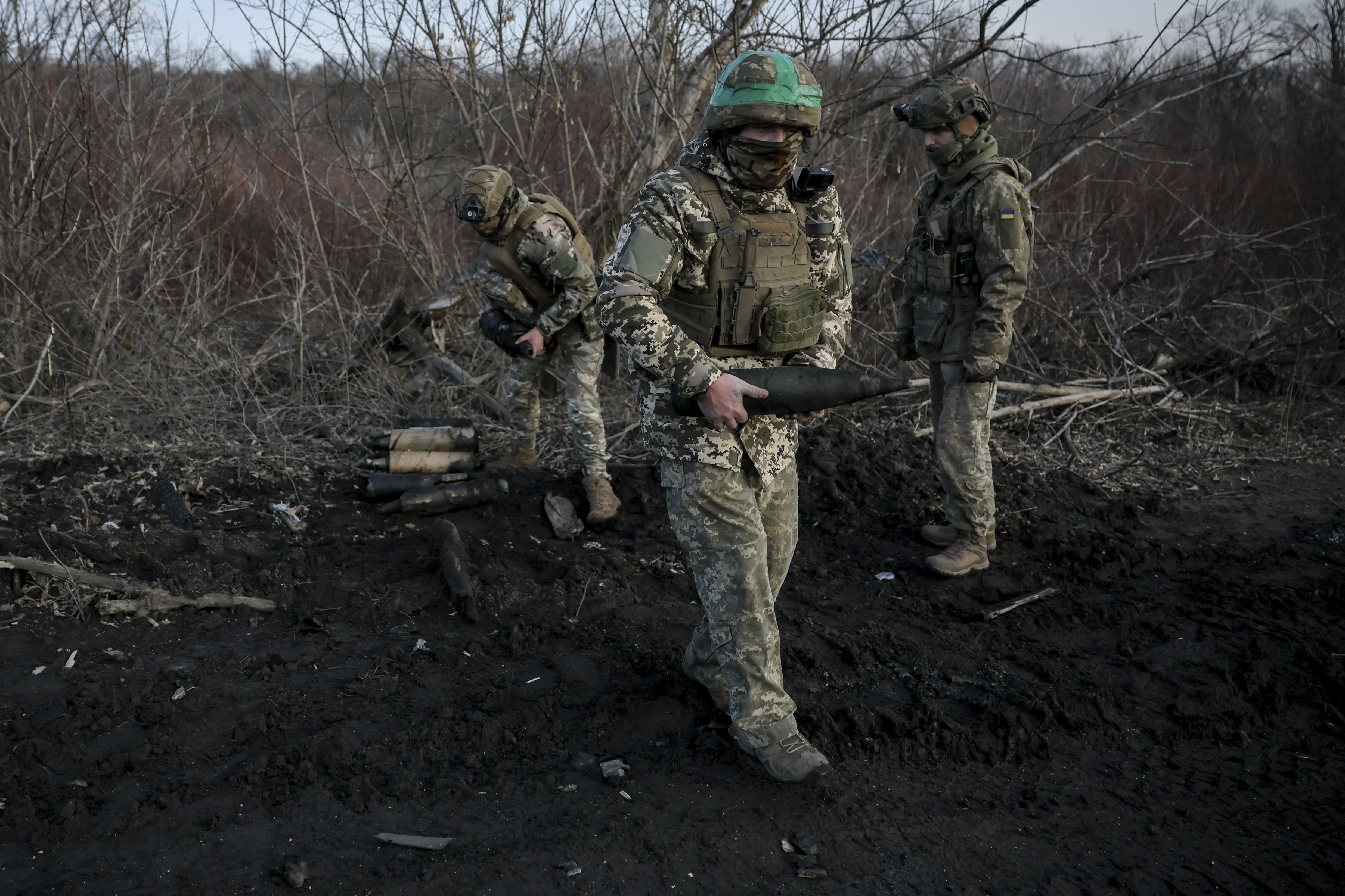 Ukrainian servicemen collect damaged ammunition on the road at the front line near Chasiv Yar town, in Donetsk region, Ukraine, Ukraine, Friday, Jan. 10, 2025. (Oleg Petrasiuk/Ukraine's 24th Mechanised Brigade via AP)