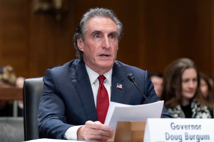 Former Gov. Doug Burgum, President-elect Donald Trump's choice to lead the the Interior Department as Secretary of the Interior, testifies before the Senate Energy and Natural Resources Committee on Capitol Hill in Washington, Thursday, Jan. 16, 2025. (AP Photo/Jose Luis Magana)