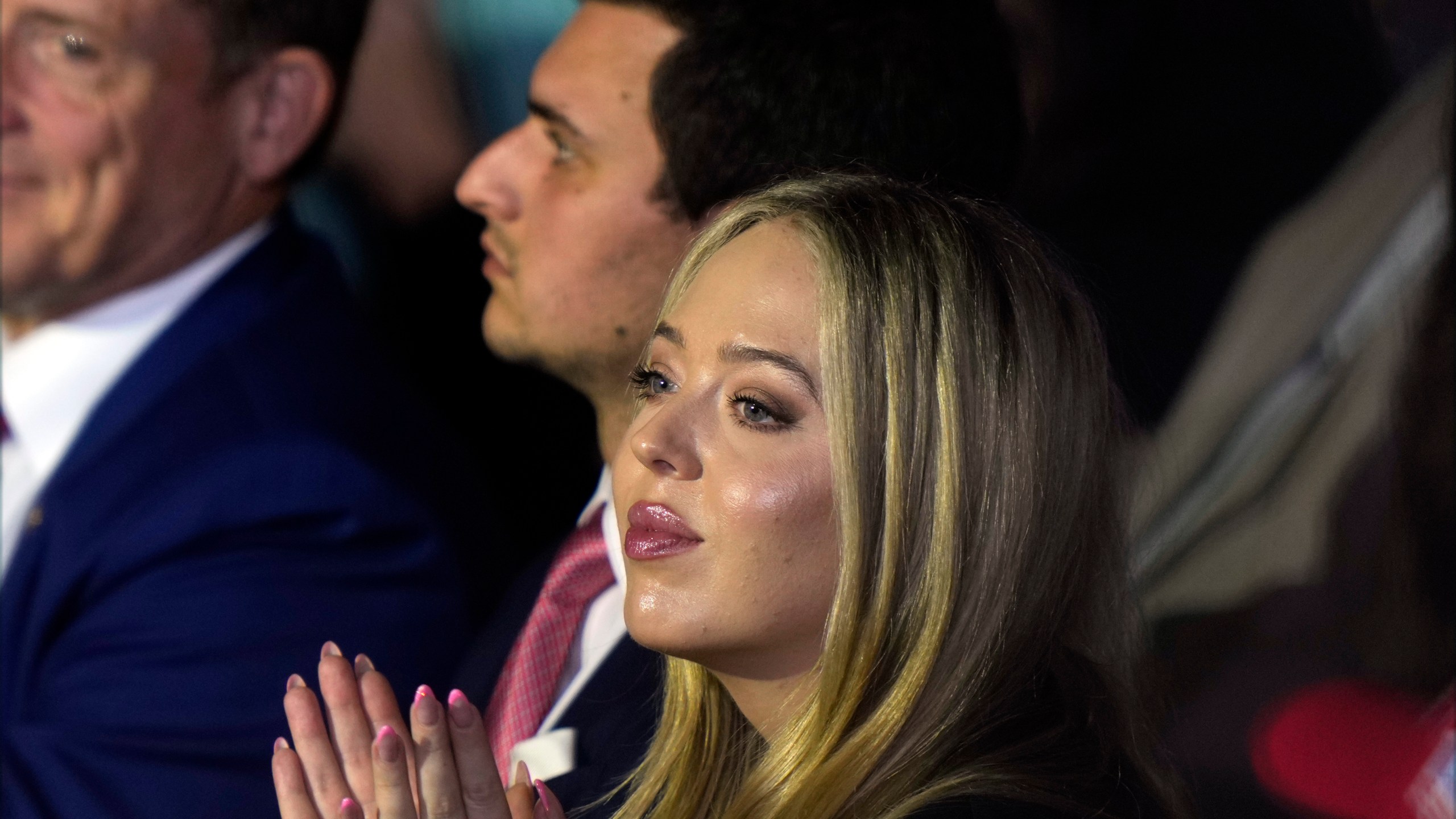 FILE - Tiffany Trump and her husband, Michael Boulos, listen as Republican presidential nominee former President Donald Trump speaks at a campaign rally at Williams Arena at Mignes Coliseum, Oct. 21, 2024, in Greenville, N.C. (AP Photo/Julia Demaree Nikhinson, File)