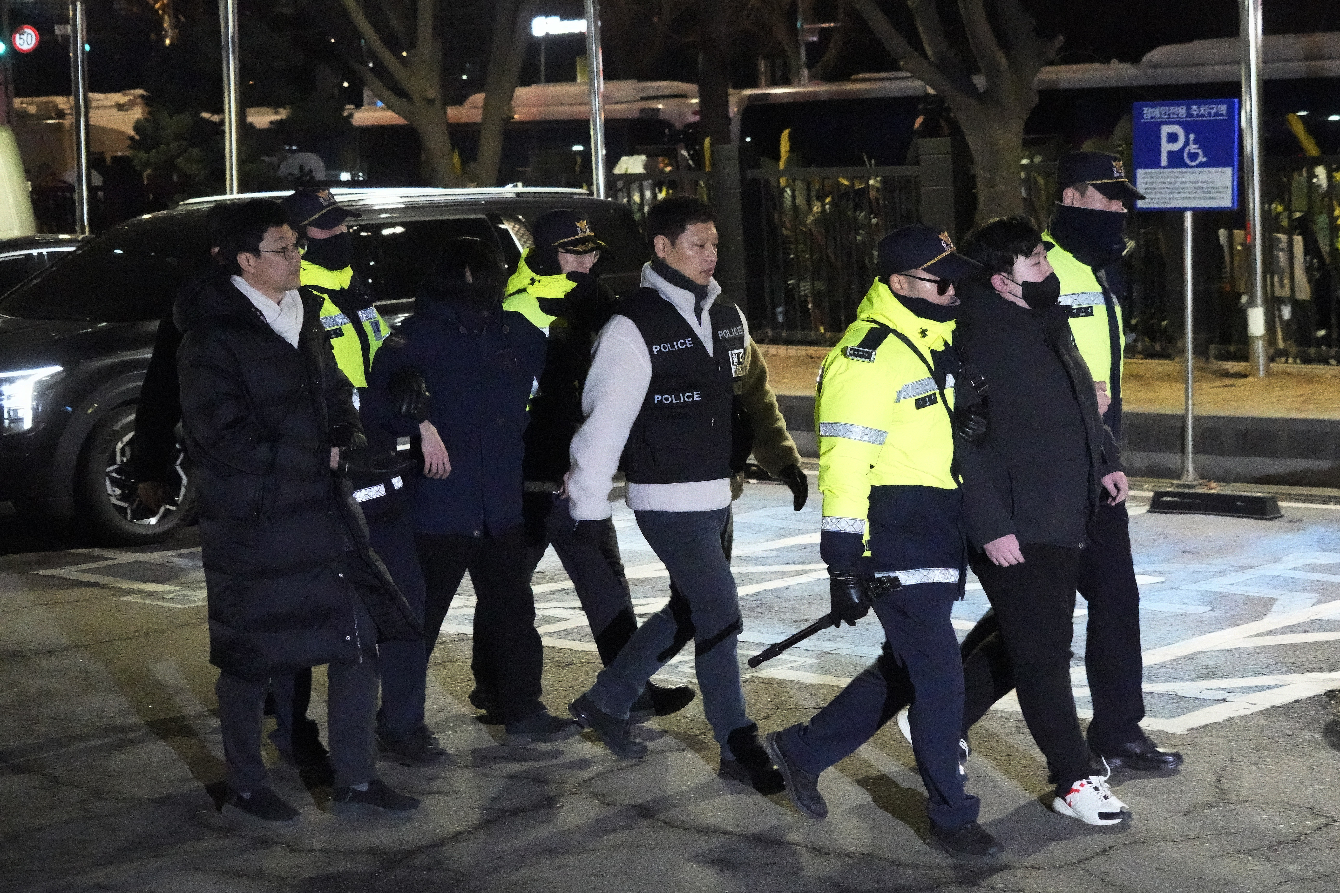 Police officers detain supporters of impeached South Korean President Yoon Suk Yeol after they illegally climbed over a fence inside the Seoul Western District Court in Seoul, South Korea, Saturday, Jan. 18, 2025. (AP Photo/Ahn Young-joon)