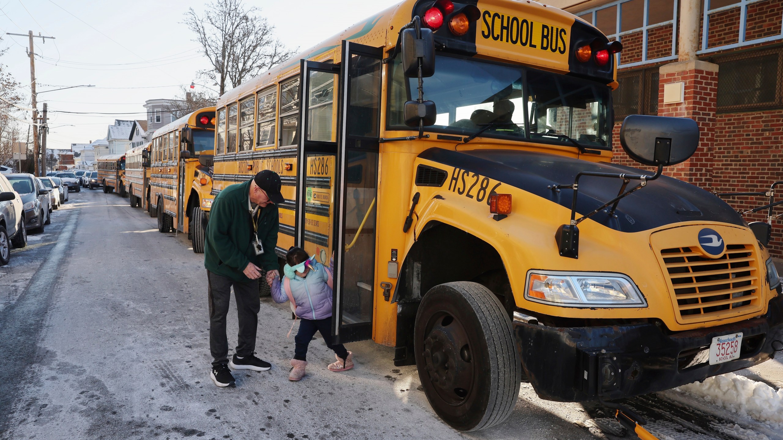 A student arrives for school Tuesday, Jan. 21, 2025, in the East Boston neighborhood of Boston. (AP Photo/Michael Dwyer)