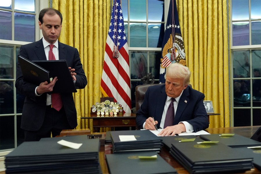 President Donald Trump signs an executive order regarding the southern border in the Oval Office of the White House, Monday, Jan. 20, 2025, in Washington. (AP Photo/Evan Vucci)