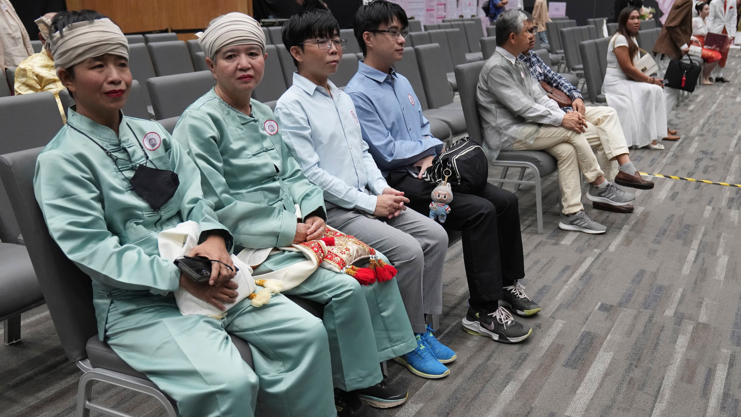 A couple from the LGBTQ+ community wait to sign their marriage certificates as the Marriage Equality Act takes effect in Bangkok, Thailand, Thursday, Jan. 23, 2025. (AP Photo/Sakchai Lalit)