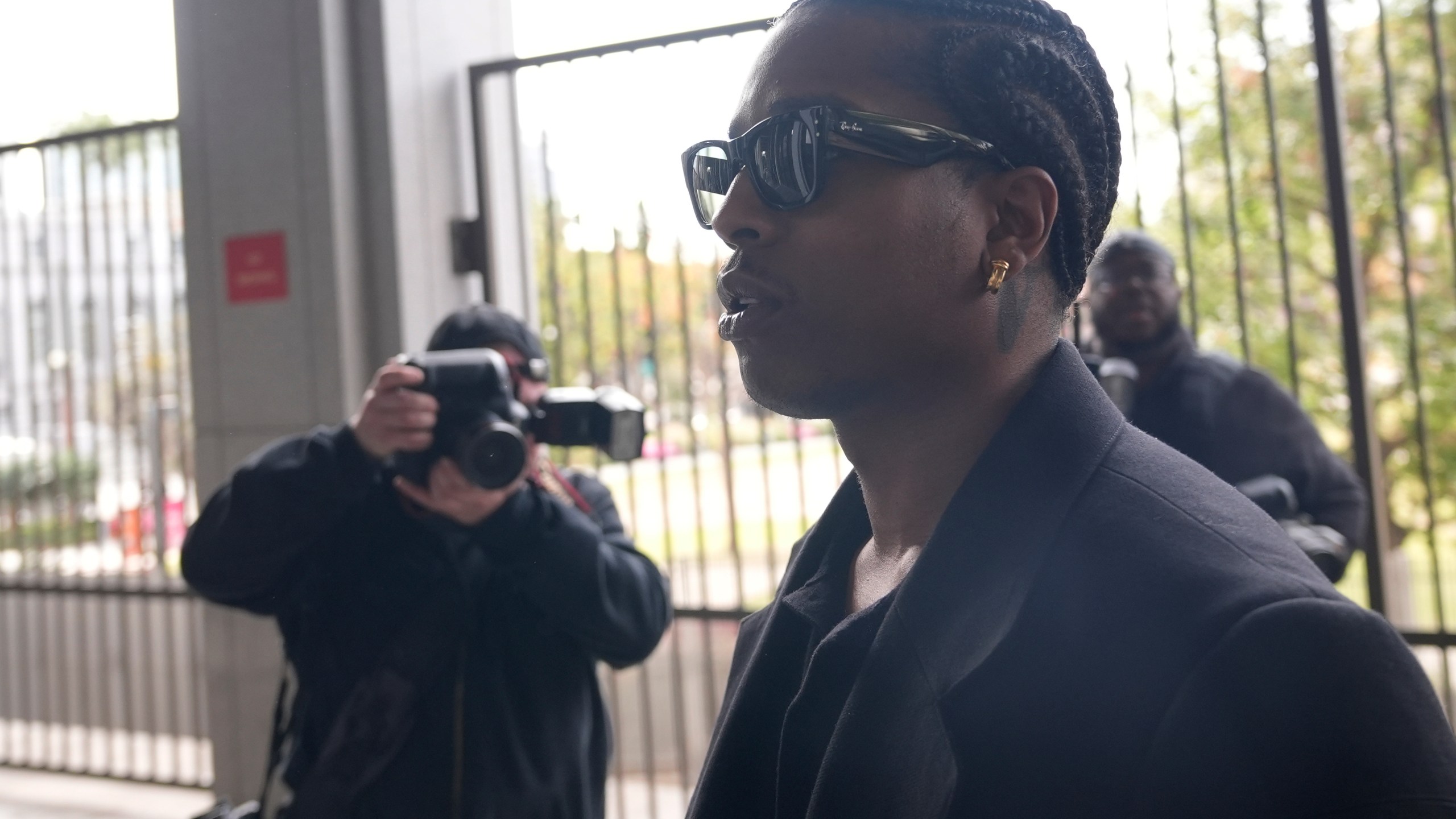 Grammy-nominated rapper A$AP Rocky, center, facing two felony counts of assault with a semiautomatic firearm after allegedly shooting at a former friend in 2021, arrives at the Clara Shortridge Foltz Criminal Justice Center in Los Angeles, Wednesday, Jan. 22, 2025. (AP Photo/Damian Dovarganes)