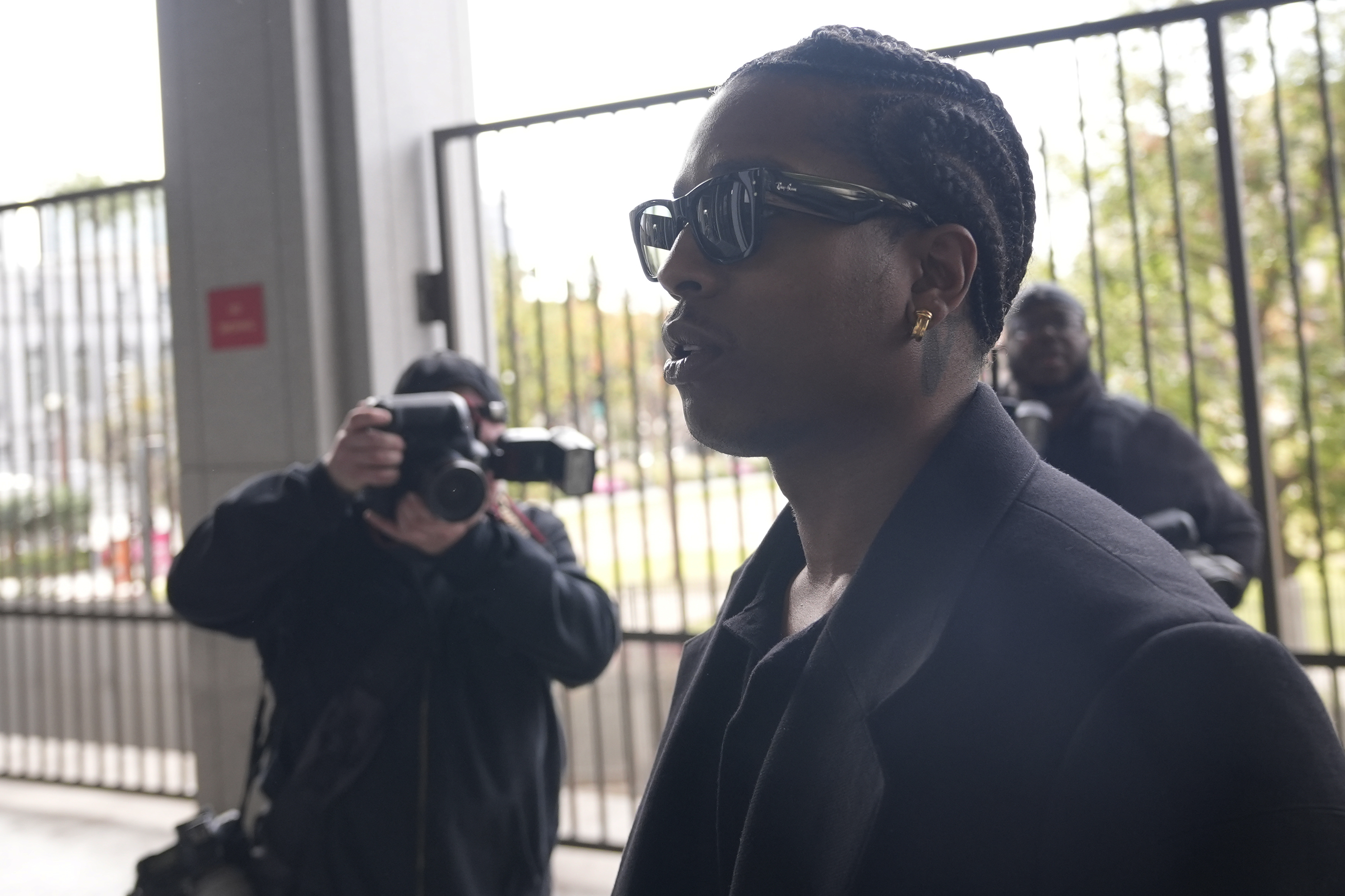 Grammy-nominated rapper A$AP Rocky, center, facing two felony counts of assault with a semiautomatic firearm after allegedly shooting at a former friend in 2021, arrives at the Clara Shortridge Foltz Criminal Justice Center in Los Angeles, Wednesday, Jan. 22, 2025. (AP Photo/Damian Dovarganes)