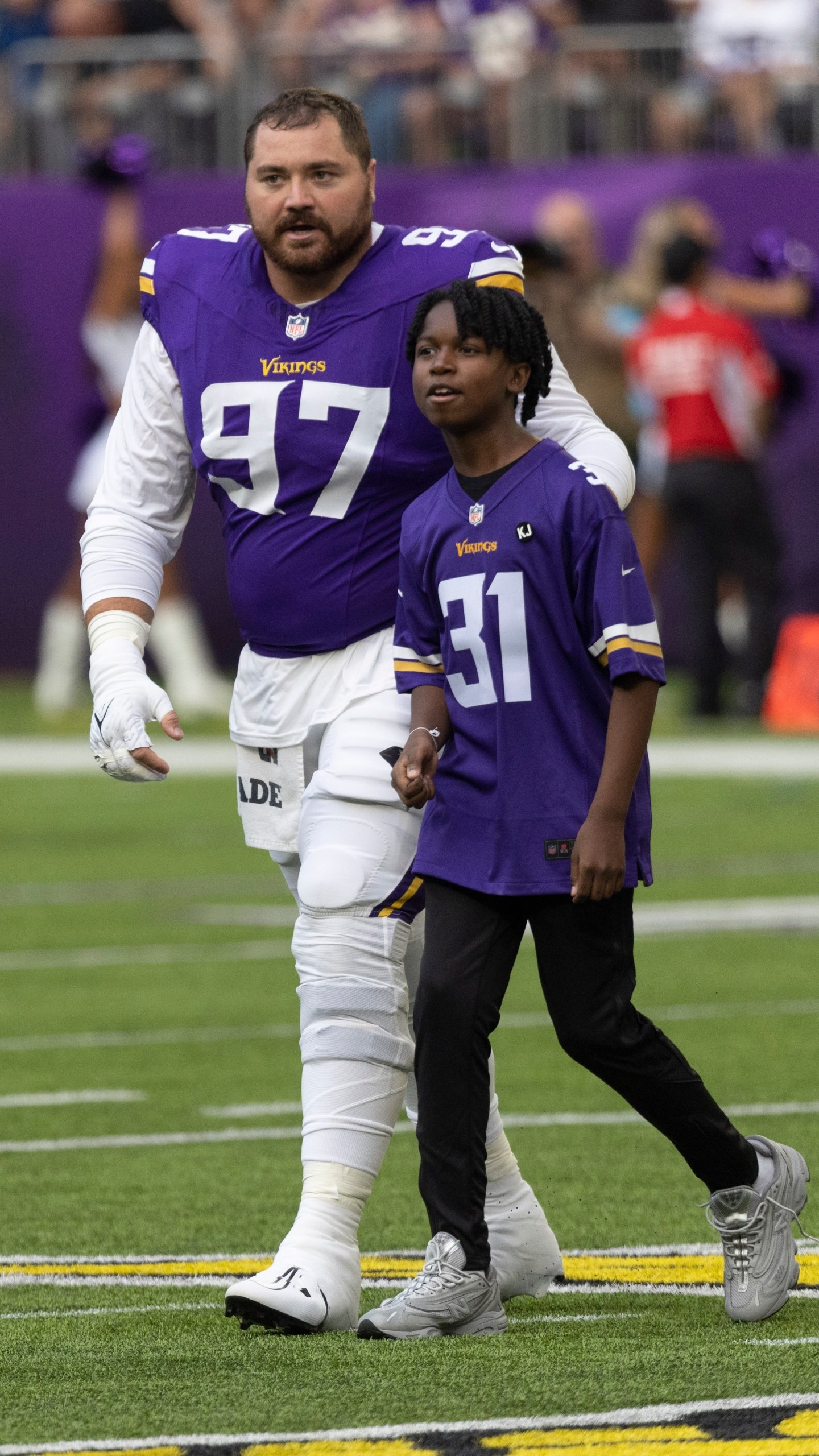 FILE - Former Minnesota Vikings rookie Khyree Jackson's brother Kolston Jackson (31) walks off the field for the coin toss with Minnesota Vikings defensive tackle Harrison Phillips (97) before an during an NFL preseason football game against the Las Vegas Raiders, Saturday, Aug. 10, 2024, in Minneapolis. (AP Photo/Andy Clayton-King, File)